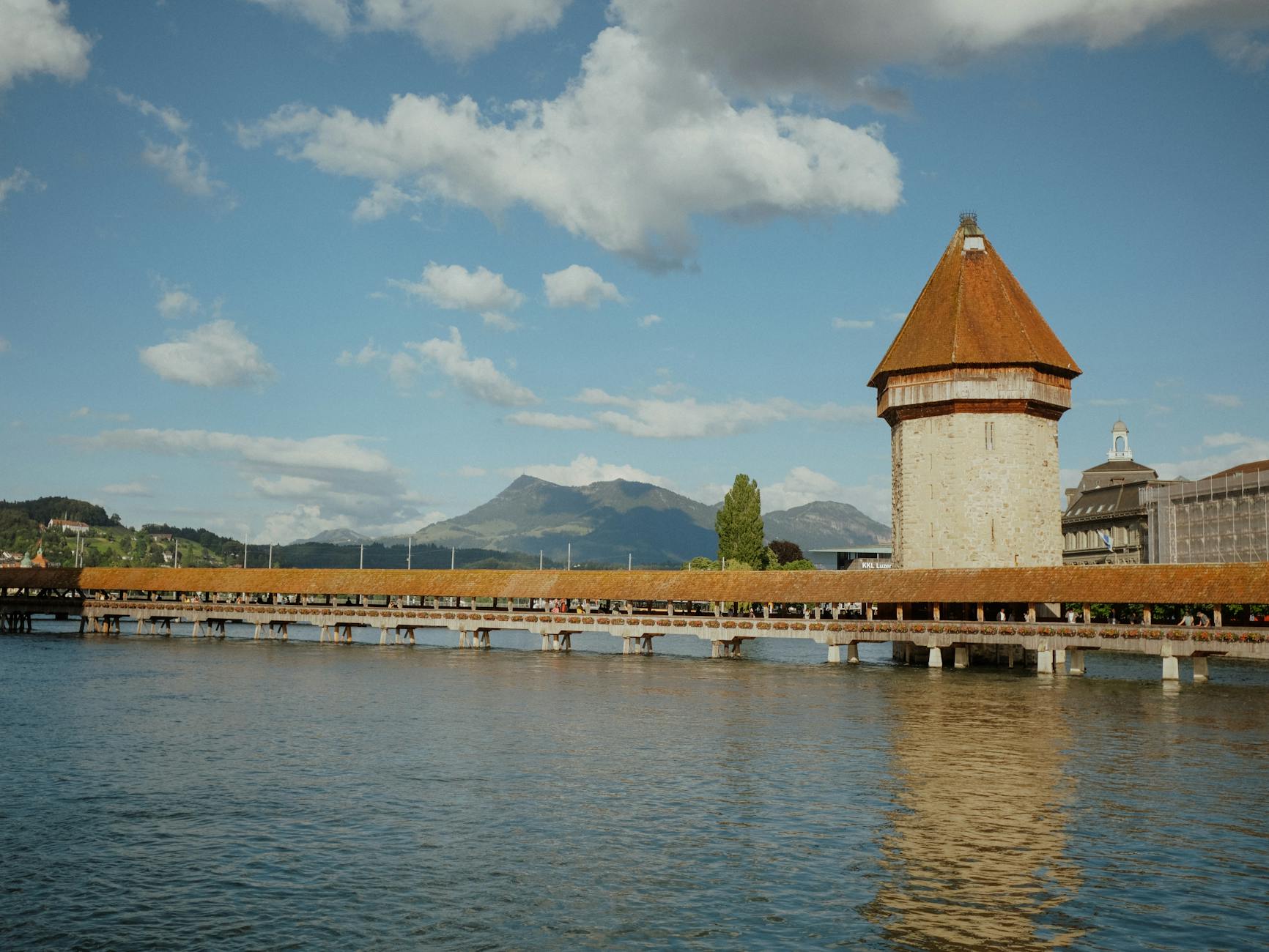 Chapel Bridge reflected in the Reuss River for lake and mountain day planning.