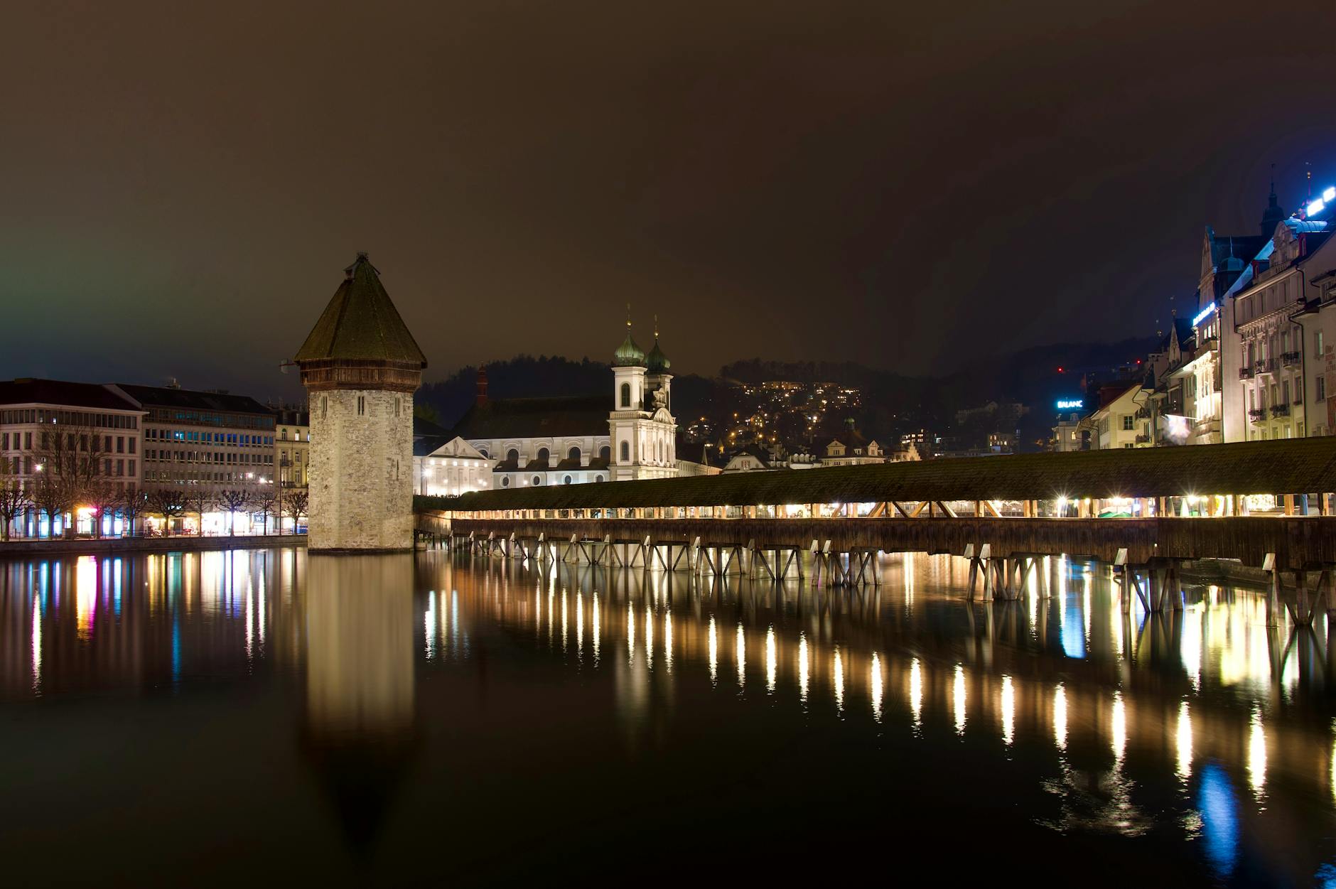 Chapel Bridge at night in Lucerne for woman traveler report planning.