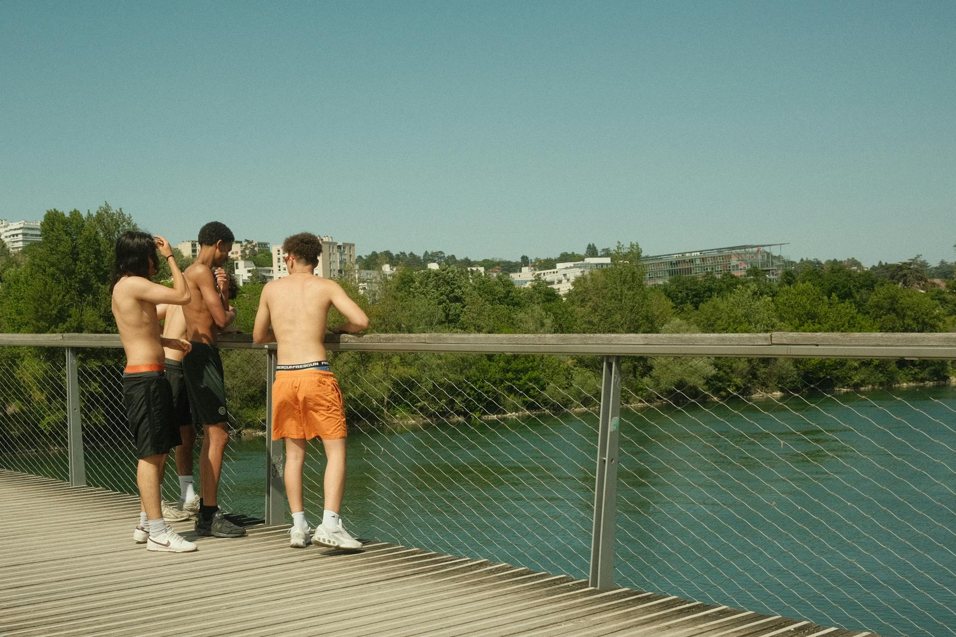 People standing on a sunny bridge in Lyon