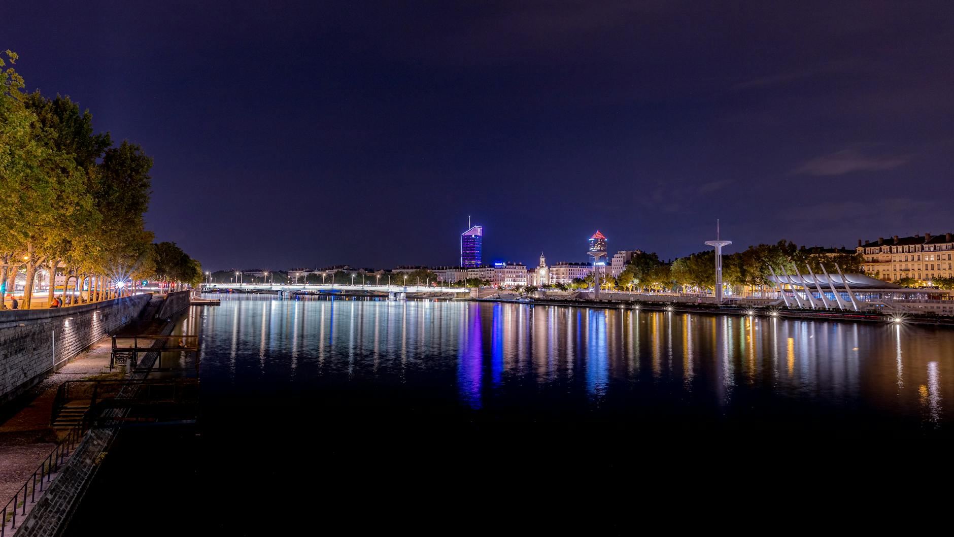 Nighttime Lyon cityscape reflected in the Rhone River