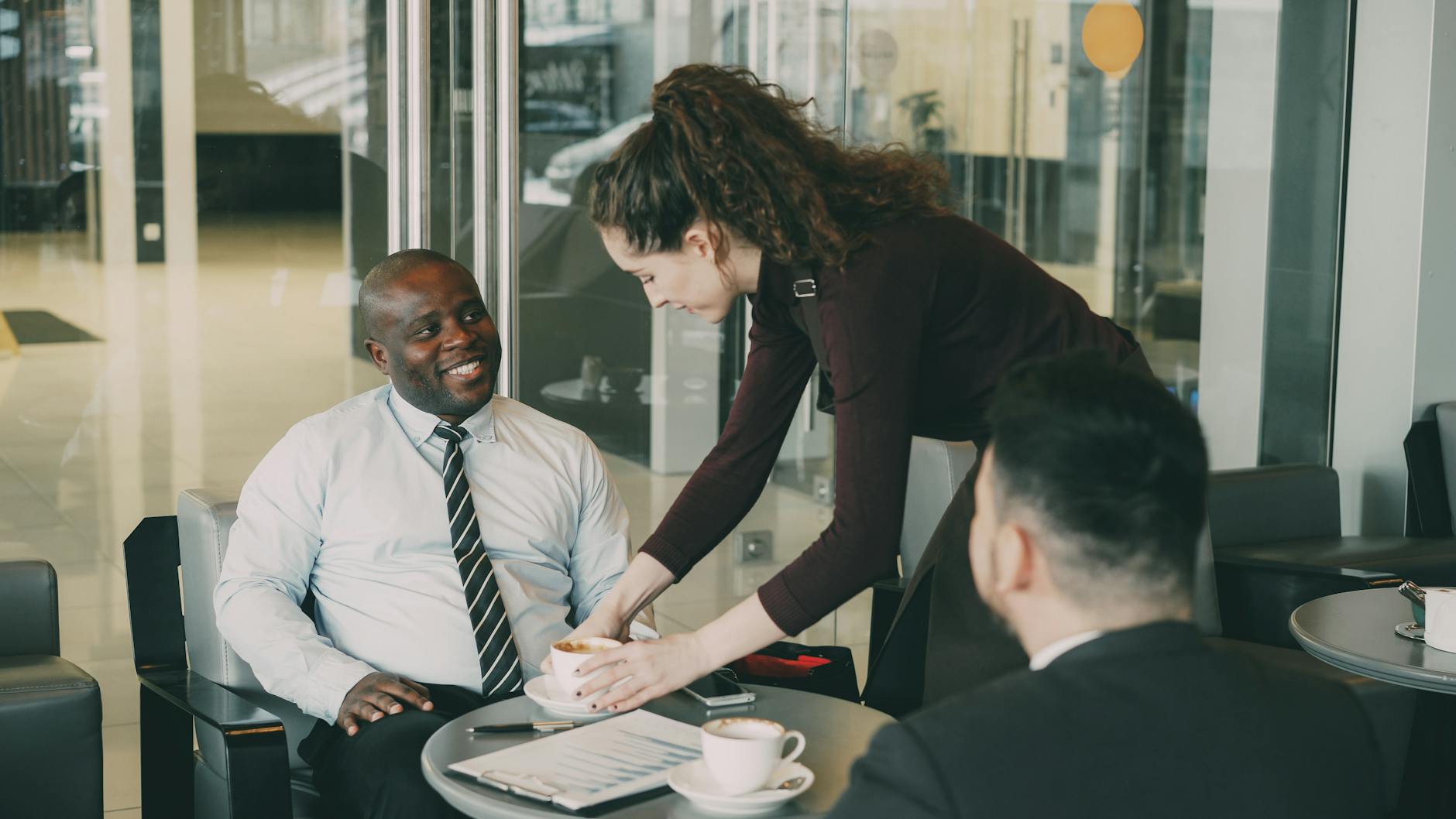 Business professionals having coffee during a meeting