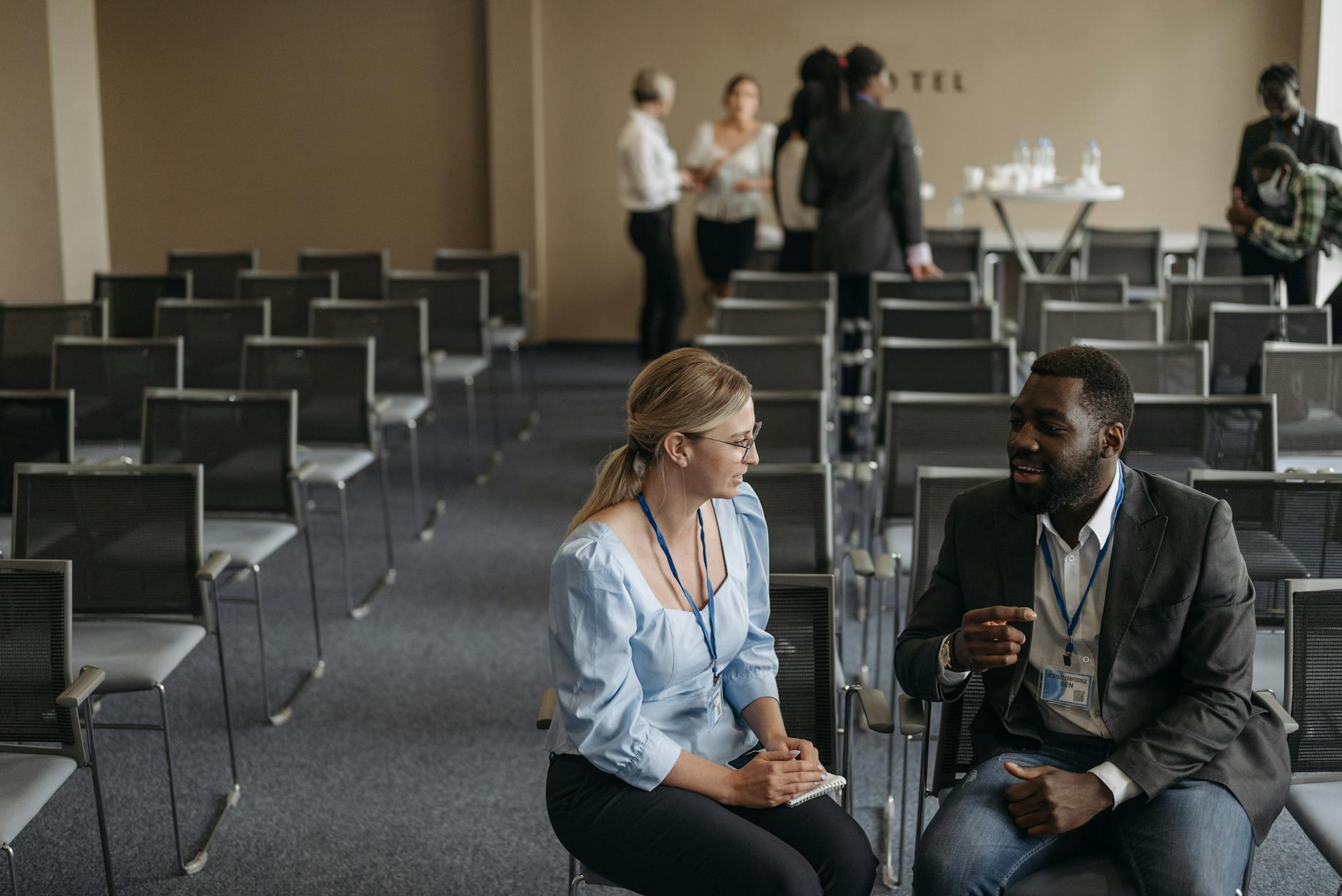 Business professionals speaking during a conference break