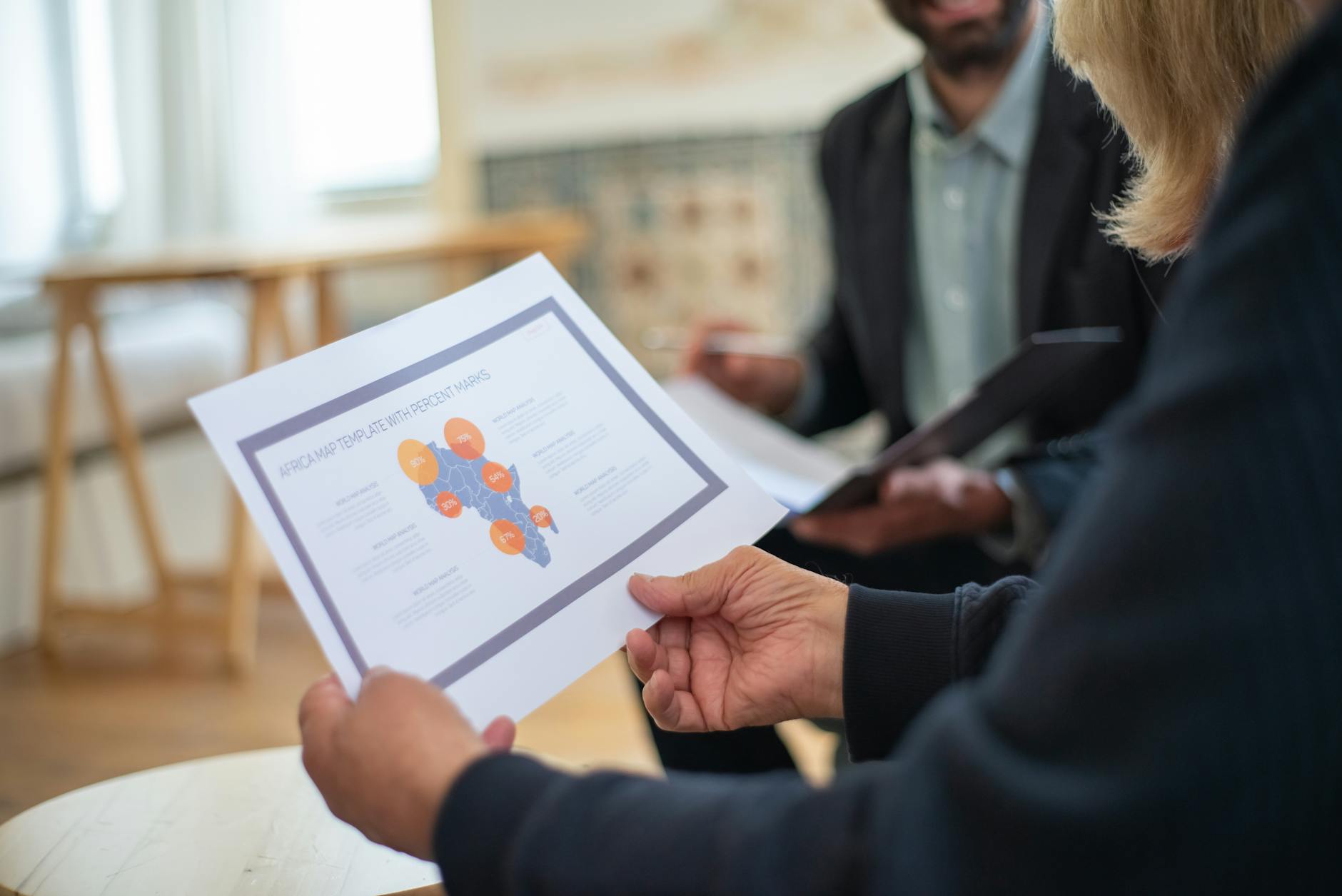 Professionals reviewing a data presentation in an office