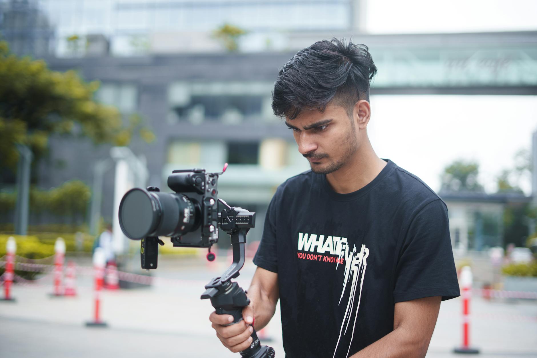 Filmmaker using a gimbal and camera outdoors