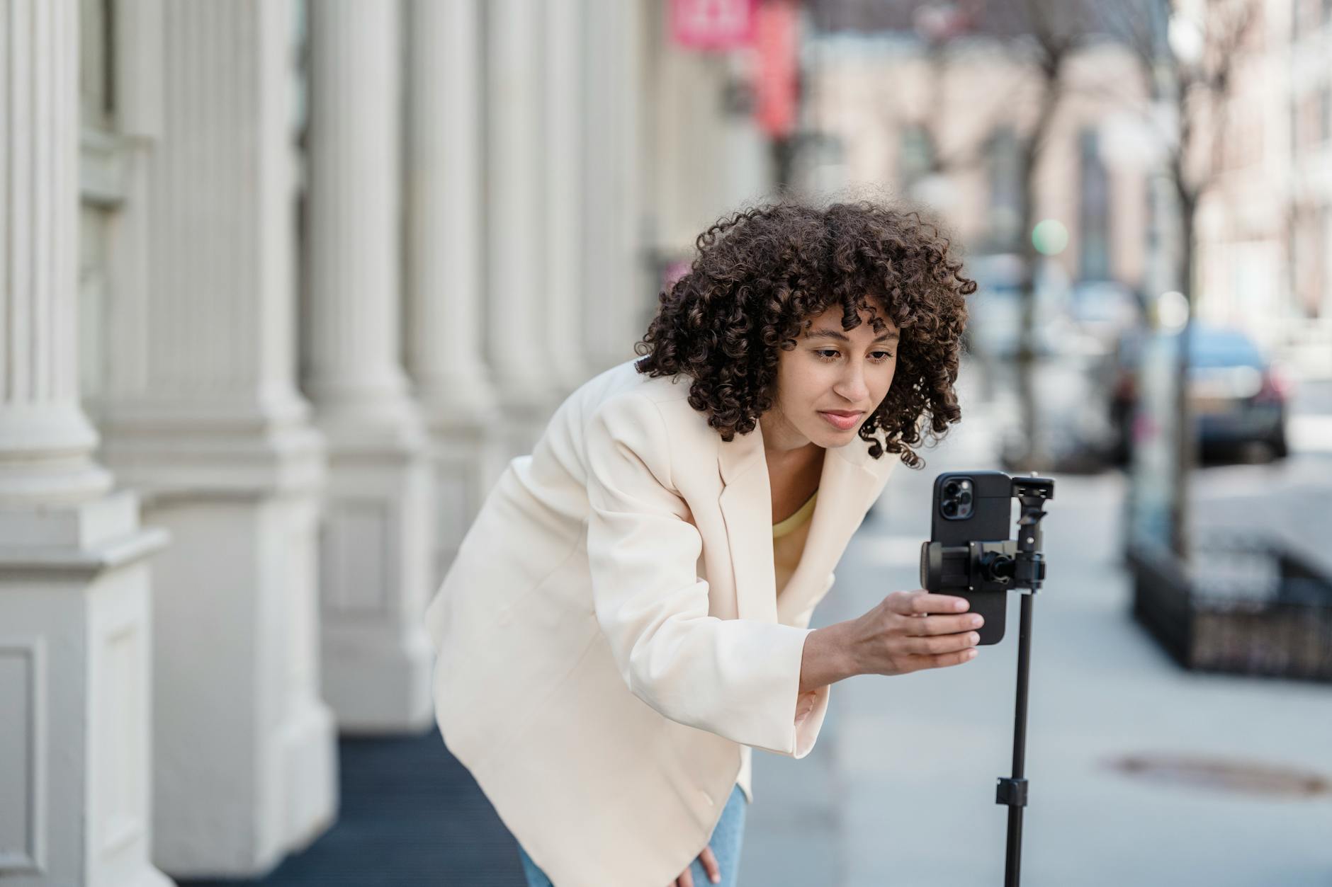 Vlogger preparing to record with a phone on a tripod