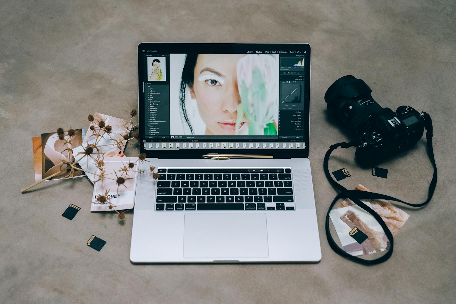 Laptop editing setup with camera and memory cards