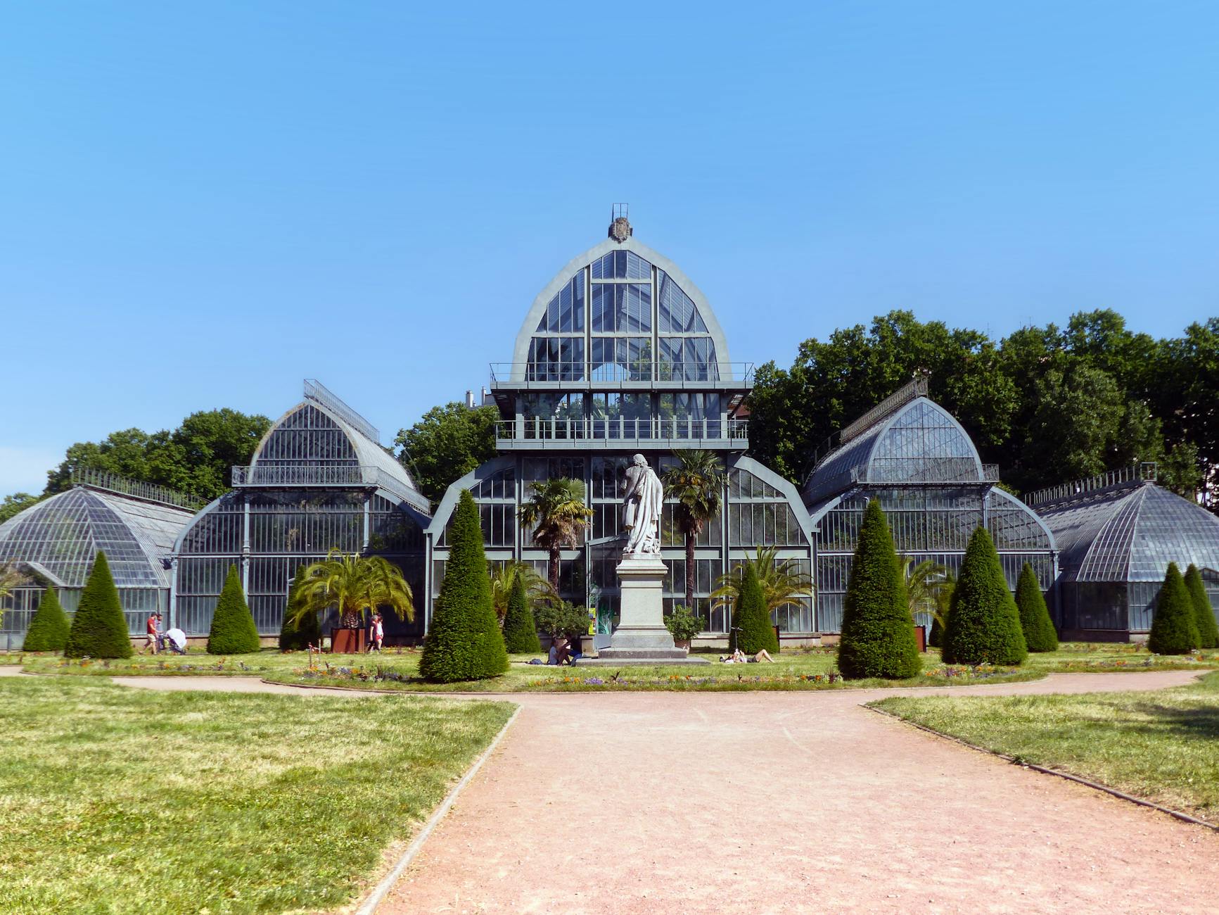 Historic botanical greenhouse and statue in Lyon