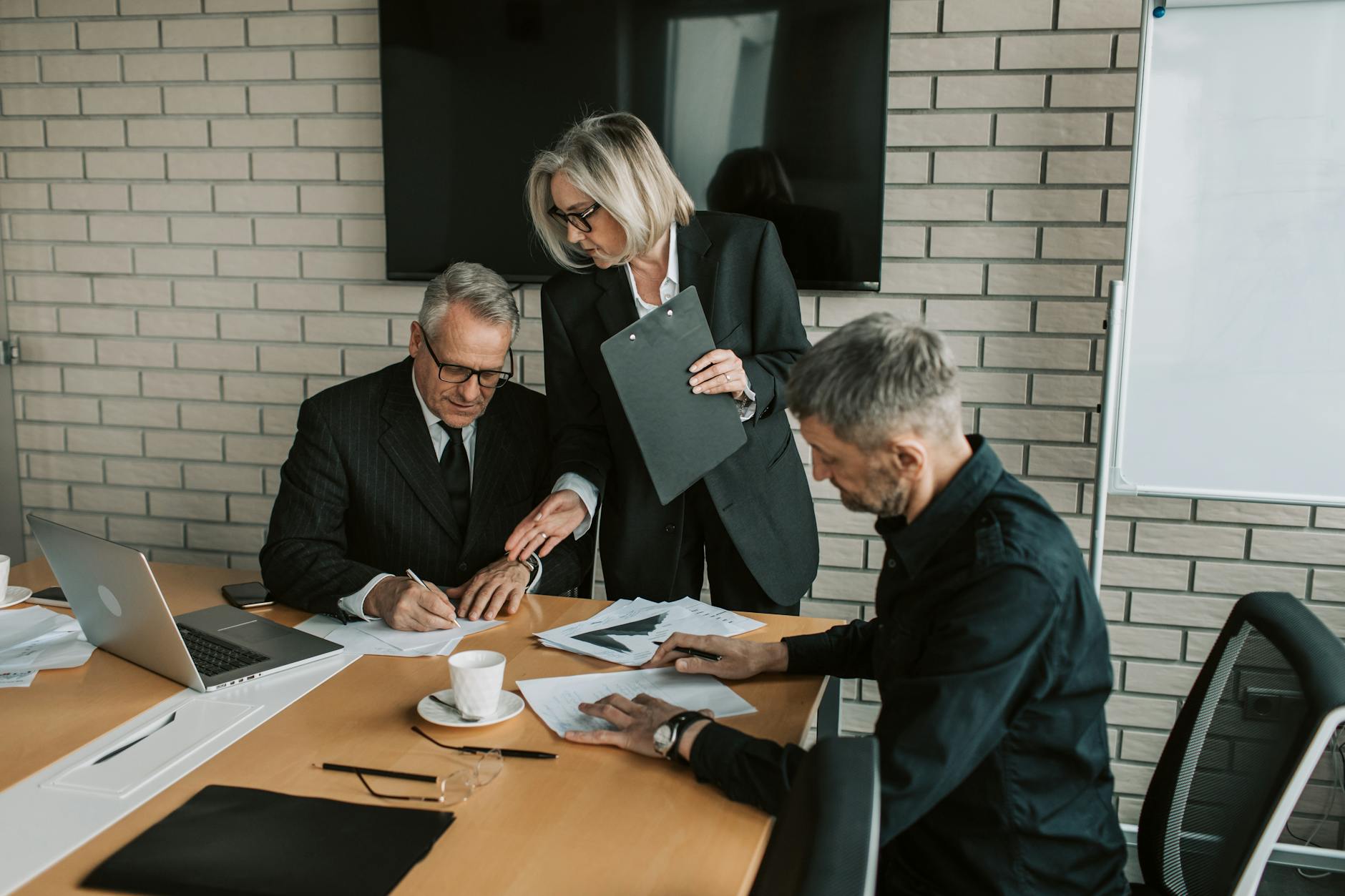 Professionals reviewing and signing business documents