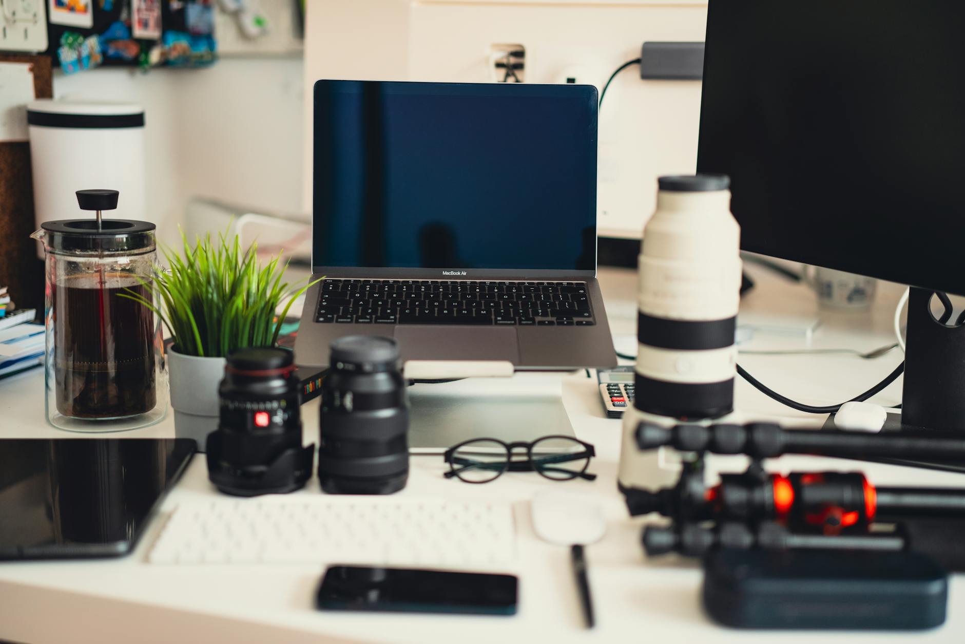 Laptop and camera equipment arranged on a desk