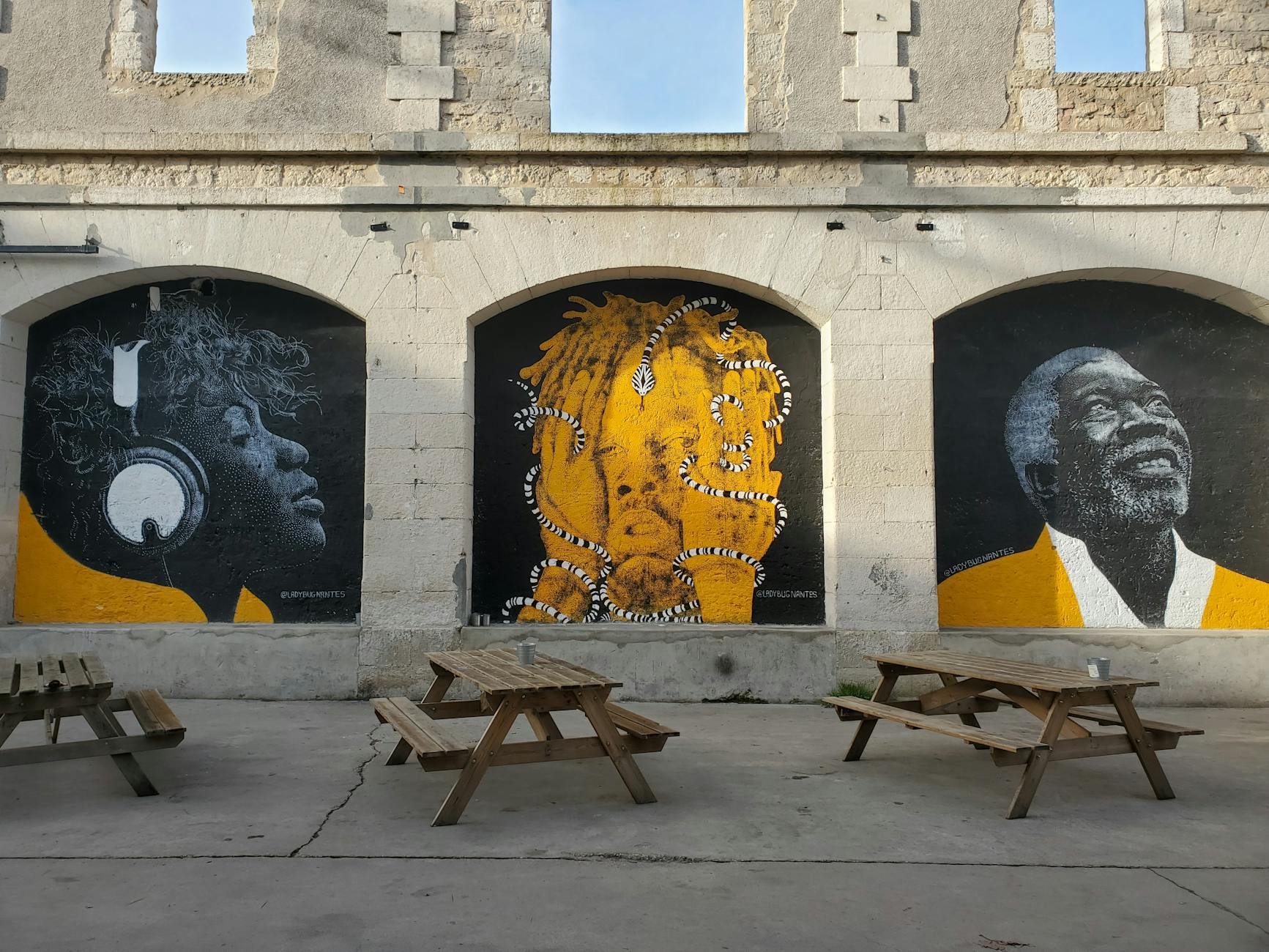 Colorful murals and benches on a Lyon wall