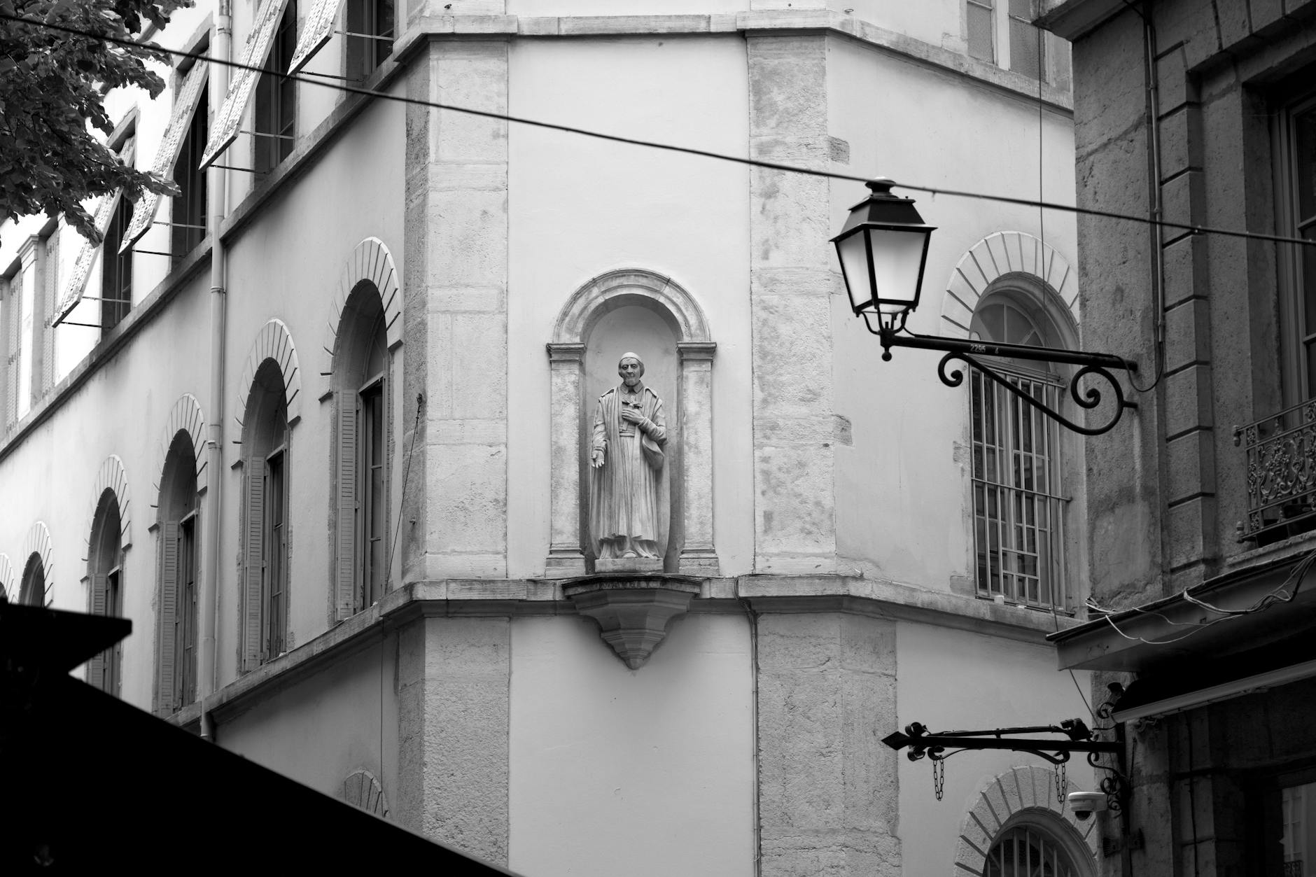 Classical building facade and statue in Lyon