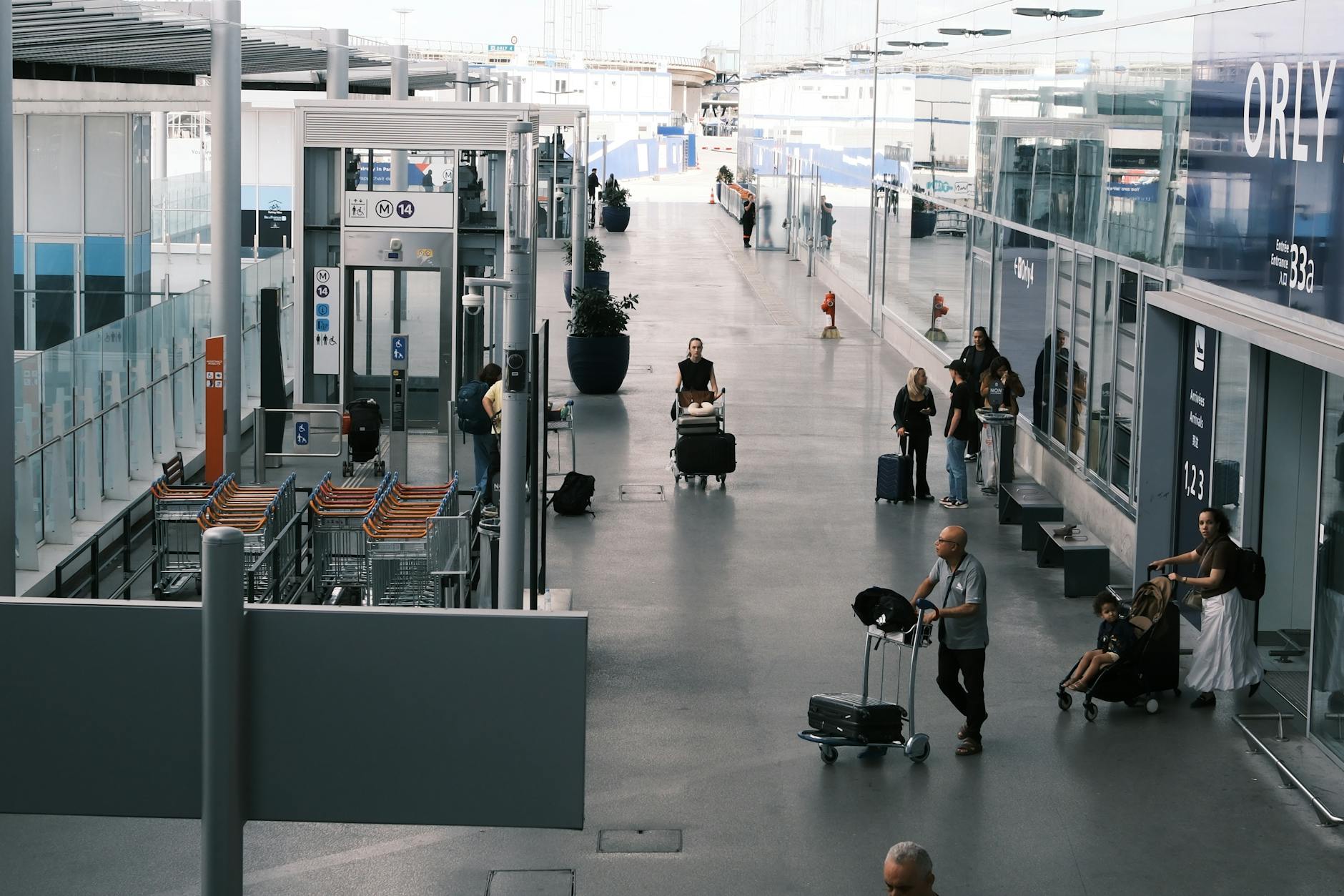 Travelers moving through an airport terminal with luggage