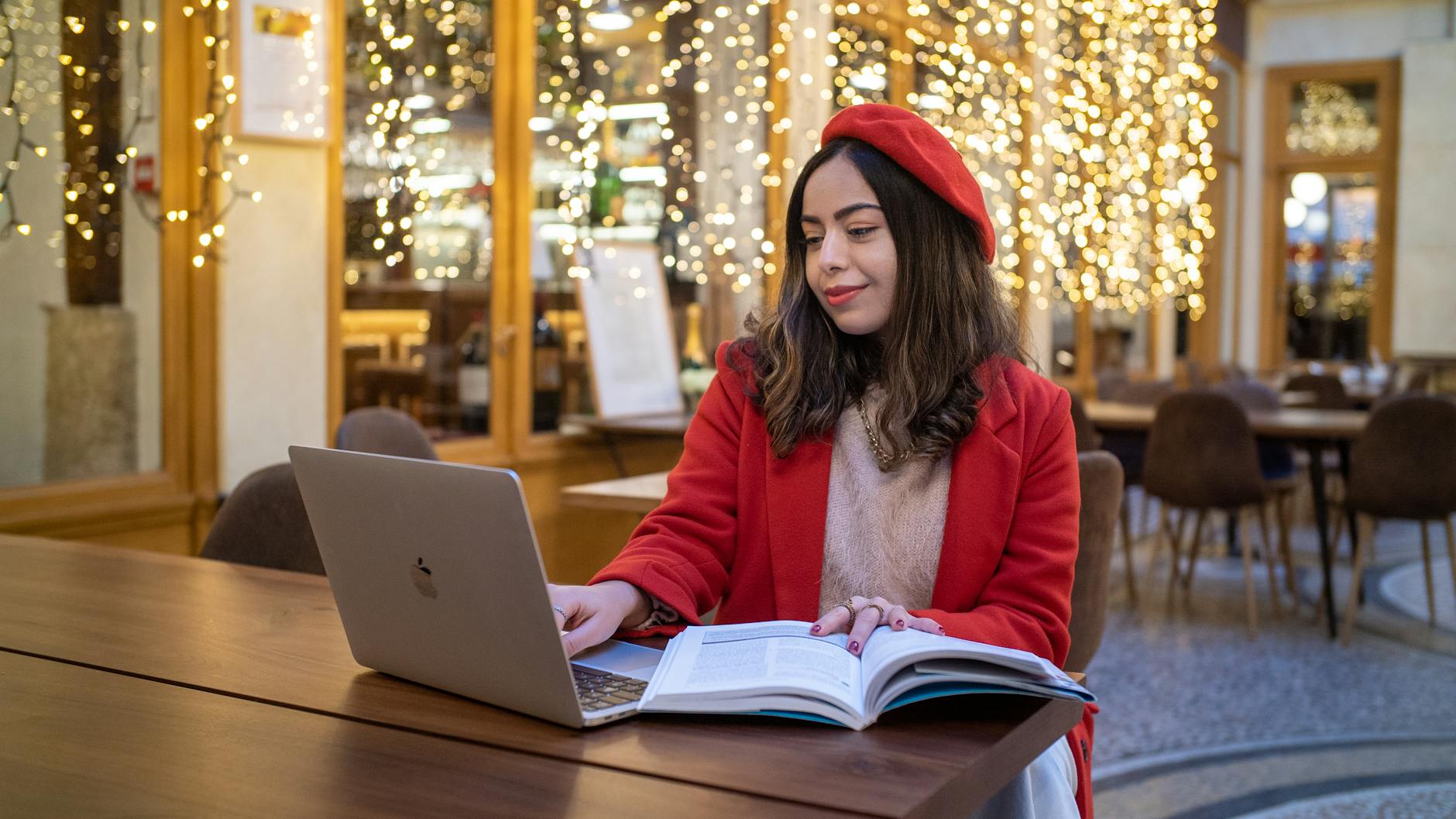 Student studying with a laptop in a French cafe