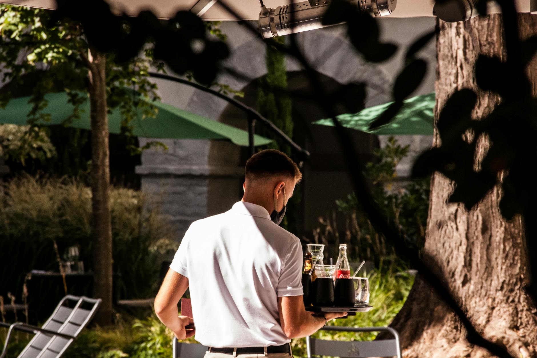 Waiter serving drinks outdoors