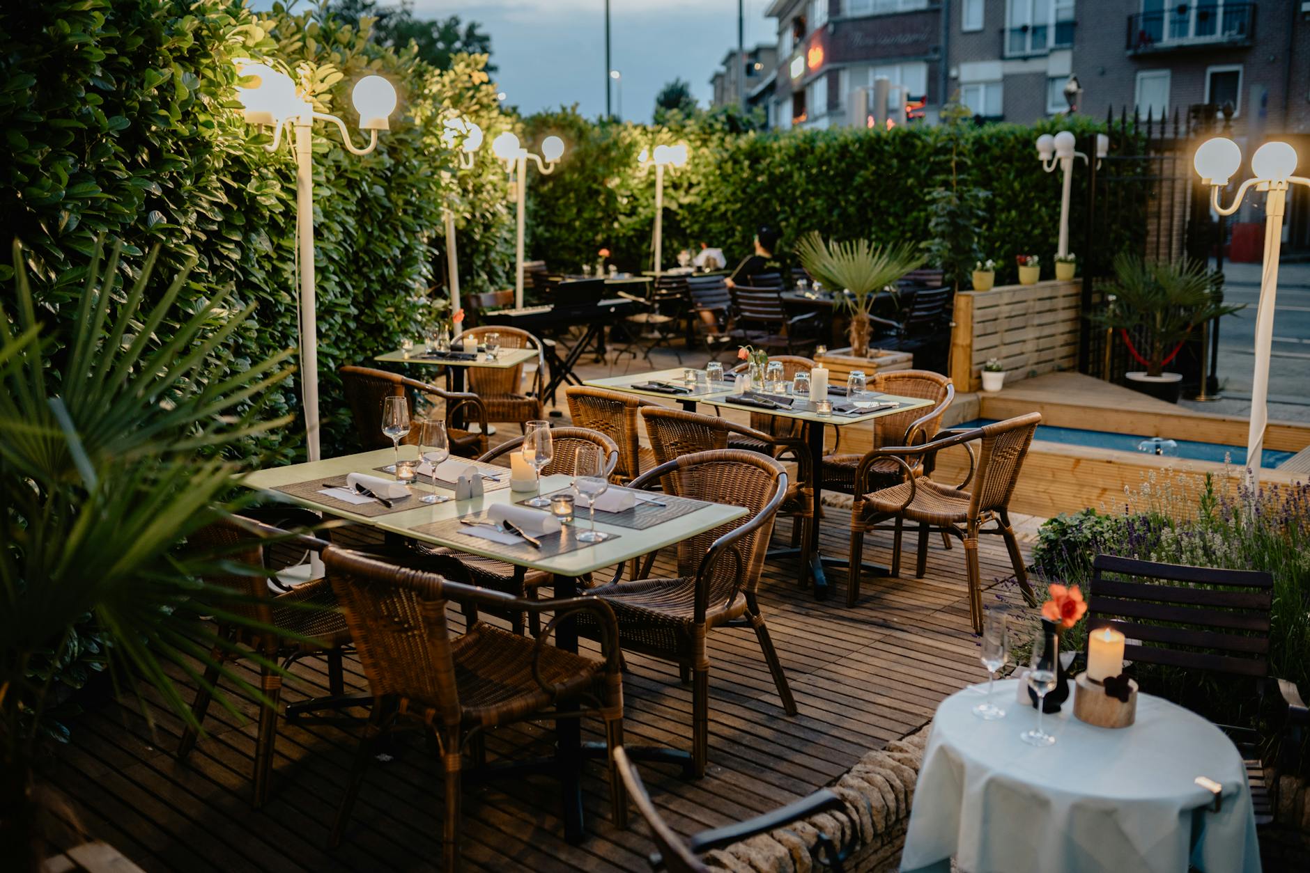 Cozy outdoor restaurant terrace prepared for evening dining