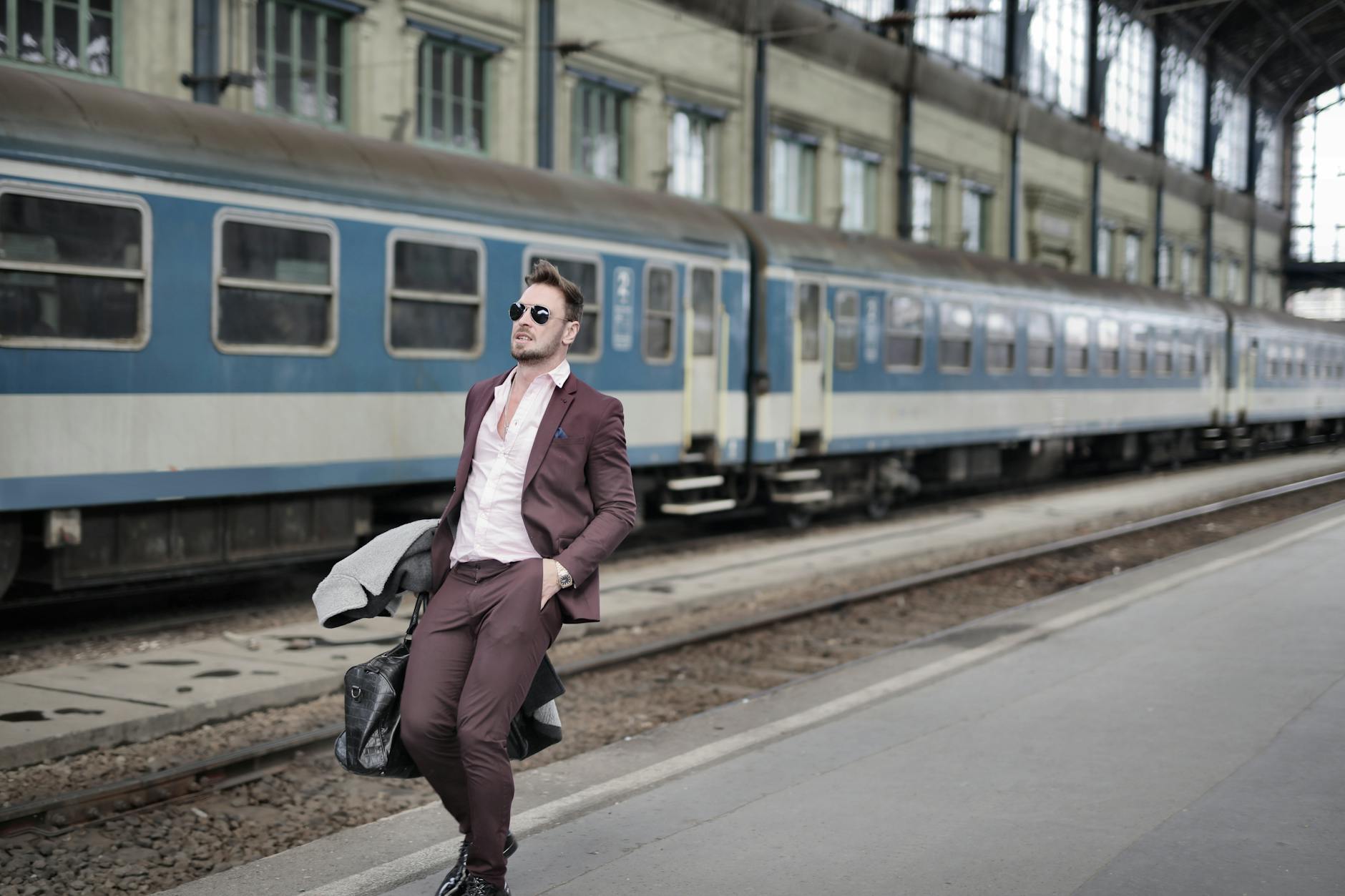 Business traveler with luggage on a rail platform