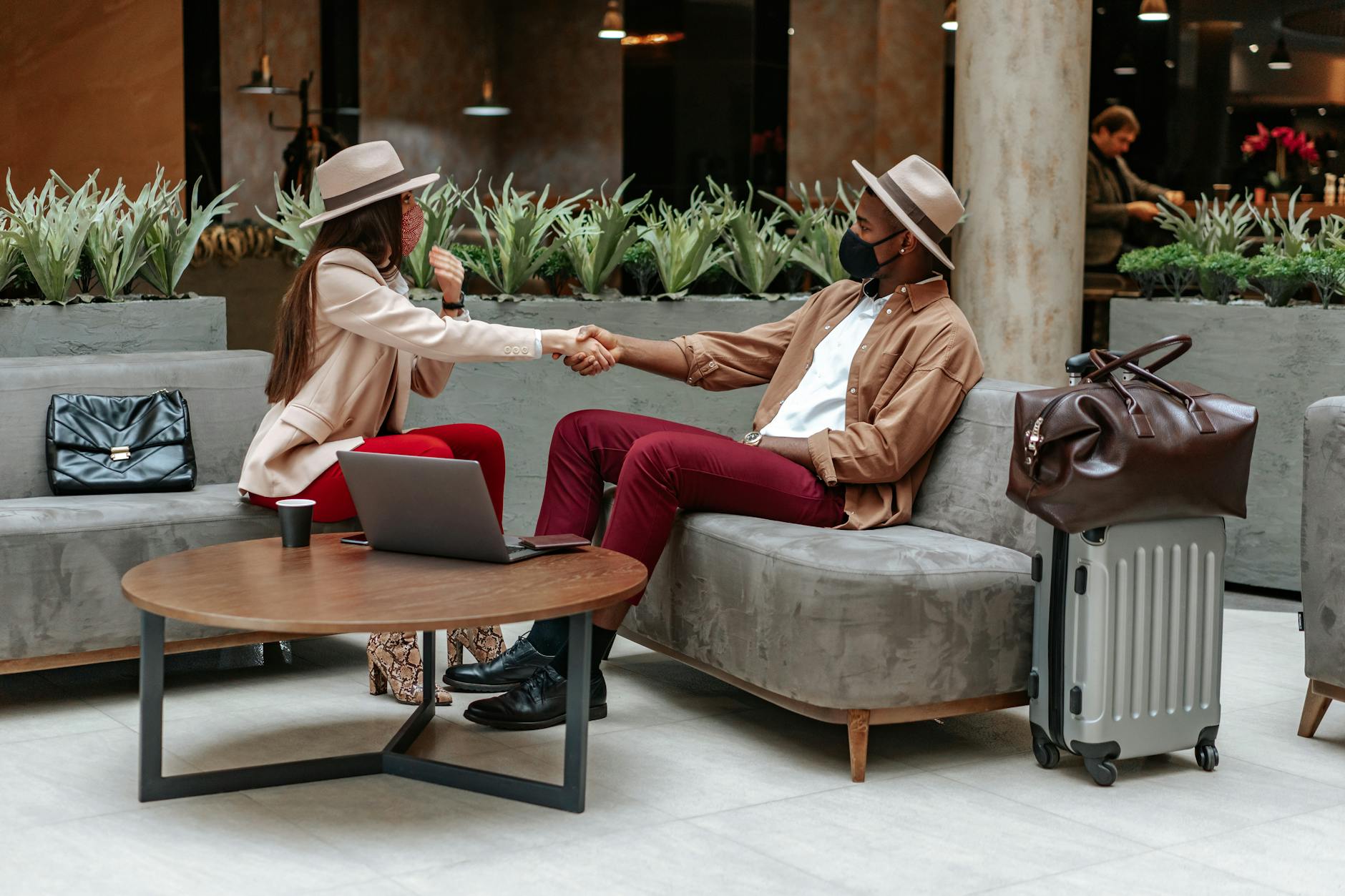 Business travelers shaking hands in a hotel lobby