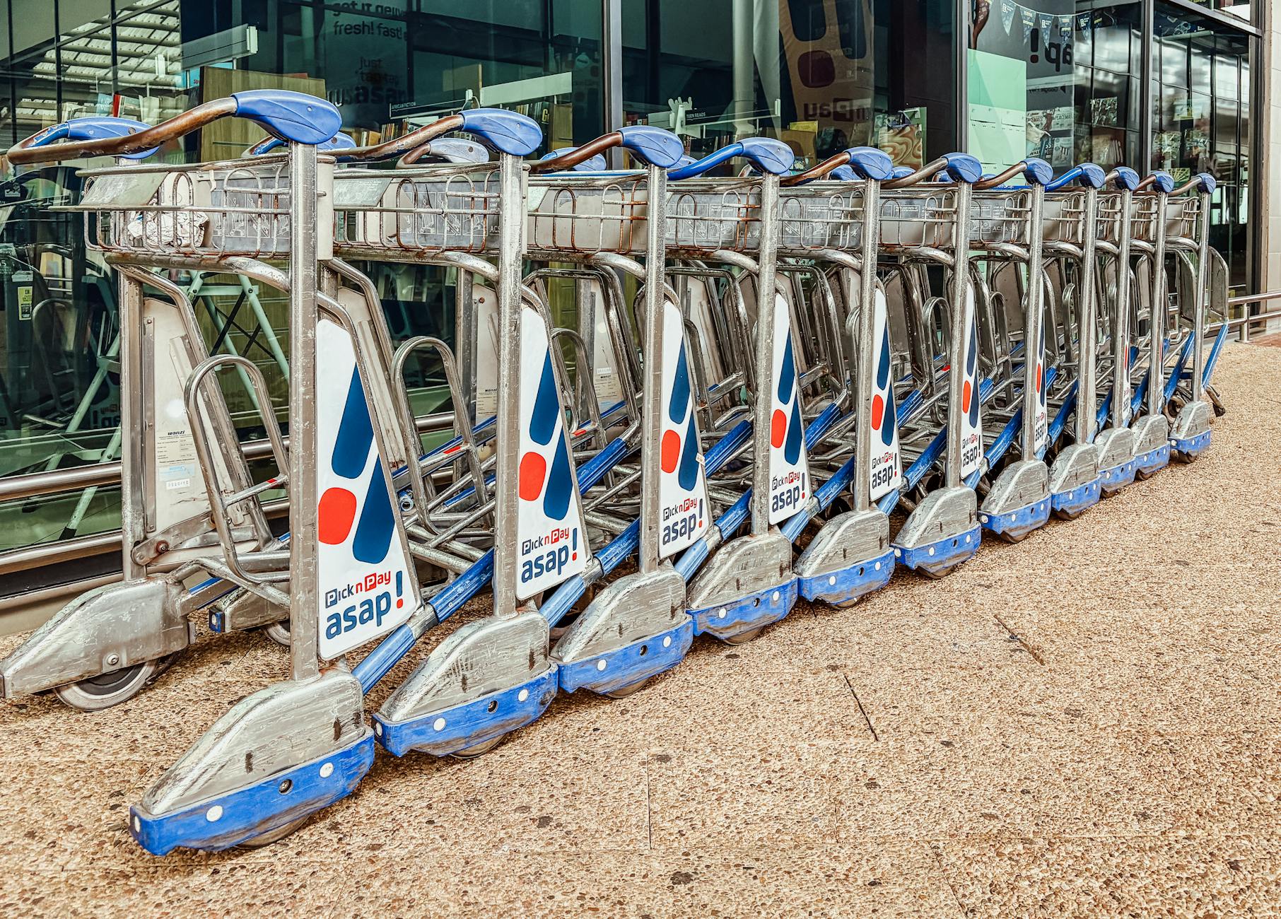 Luggage trolleys arranged outside an airport terminal