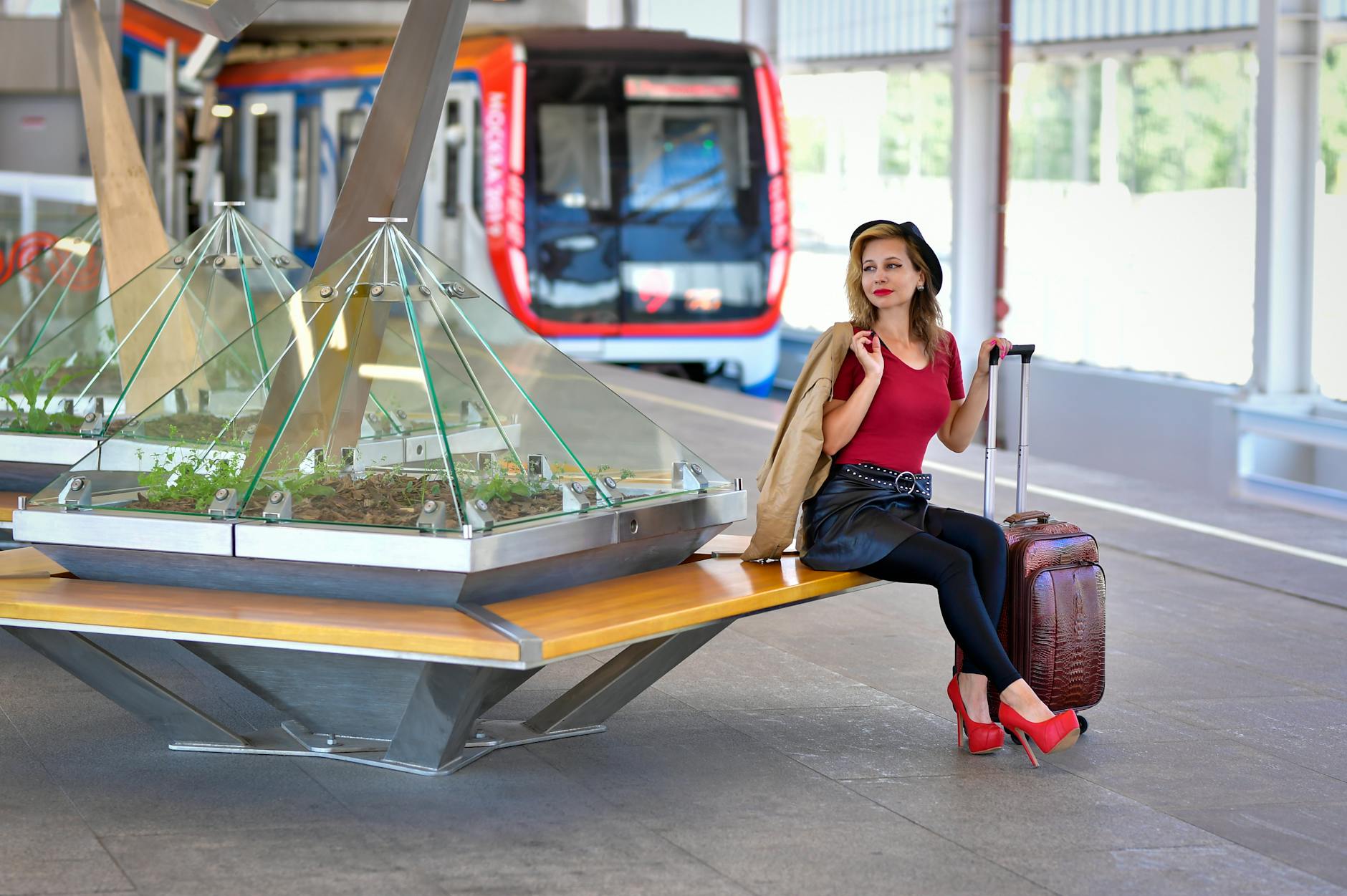Traveler with suitcase waiting at a railway station