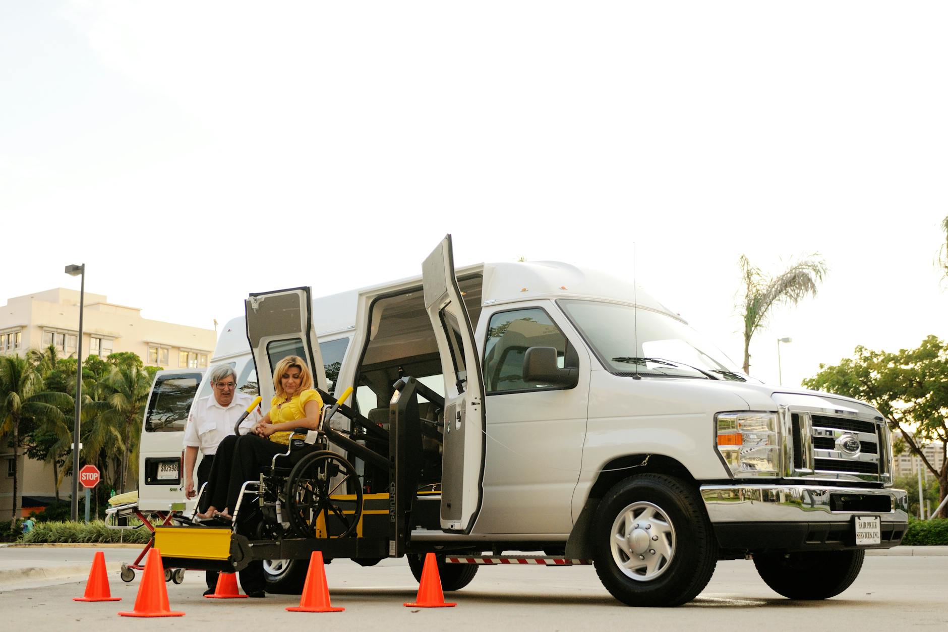 Wheelchair user boarding an accessible vehicle with assistance
