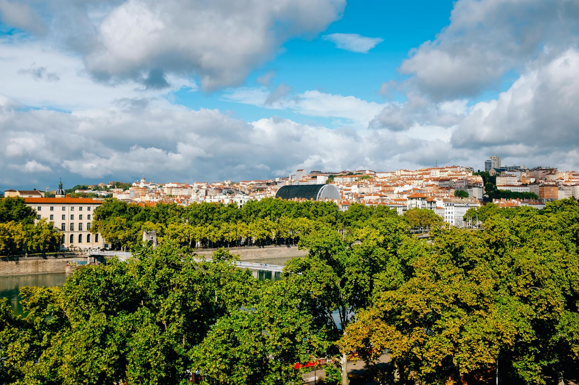 River-level urban scenery with trees and buildings