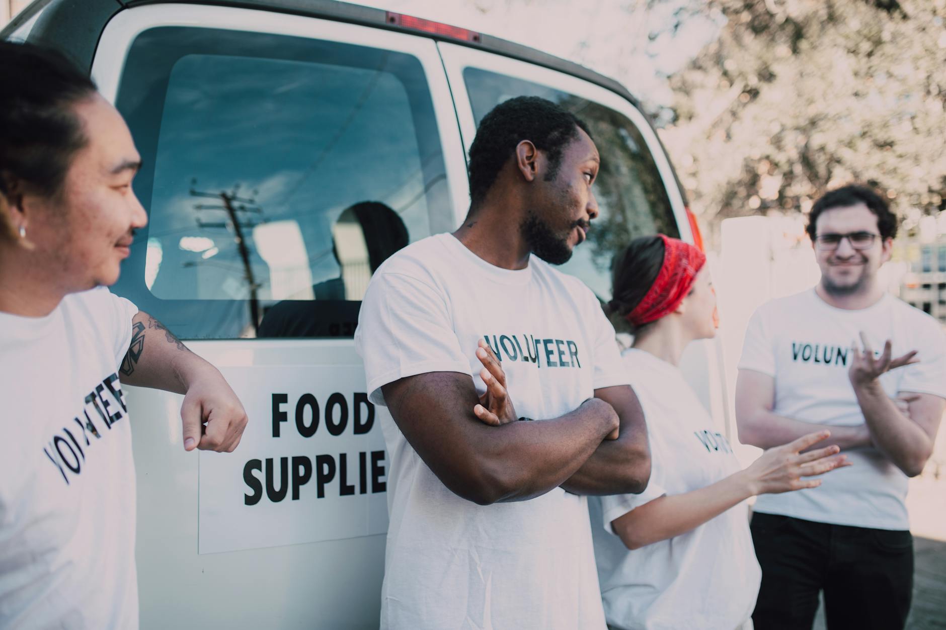 Volunteers preparing food supplies beside a van