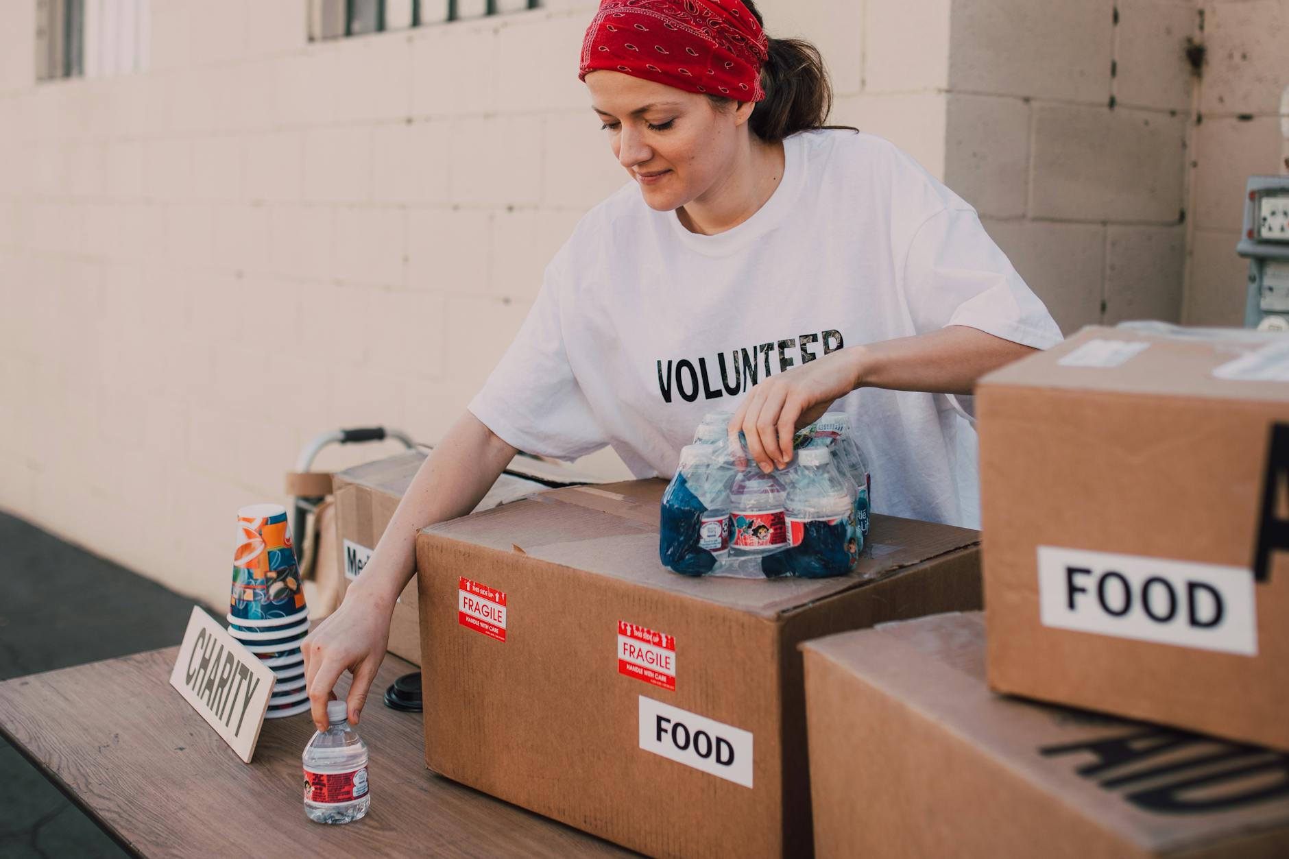 Volunteer sorting food and water at an aid center