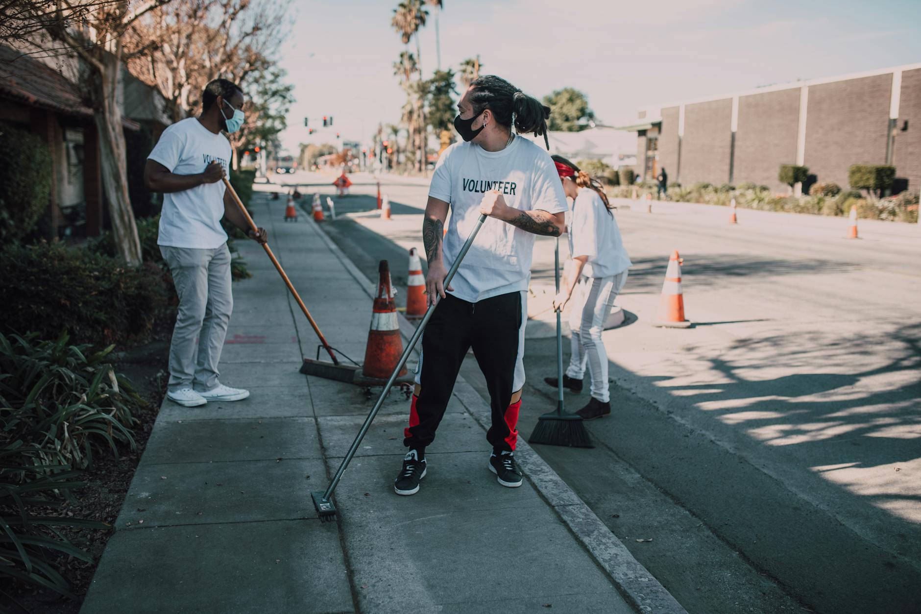 Volunteers cleaning an urban sidewalk