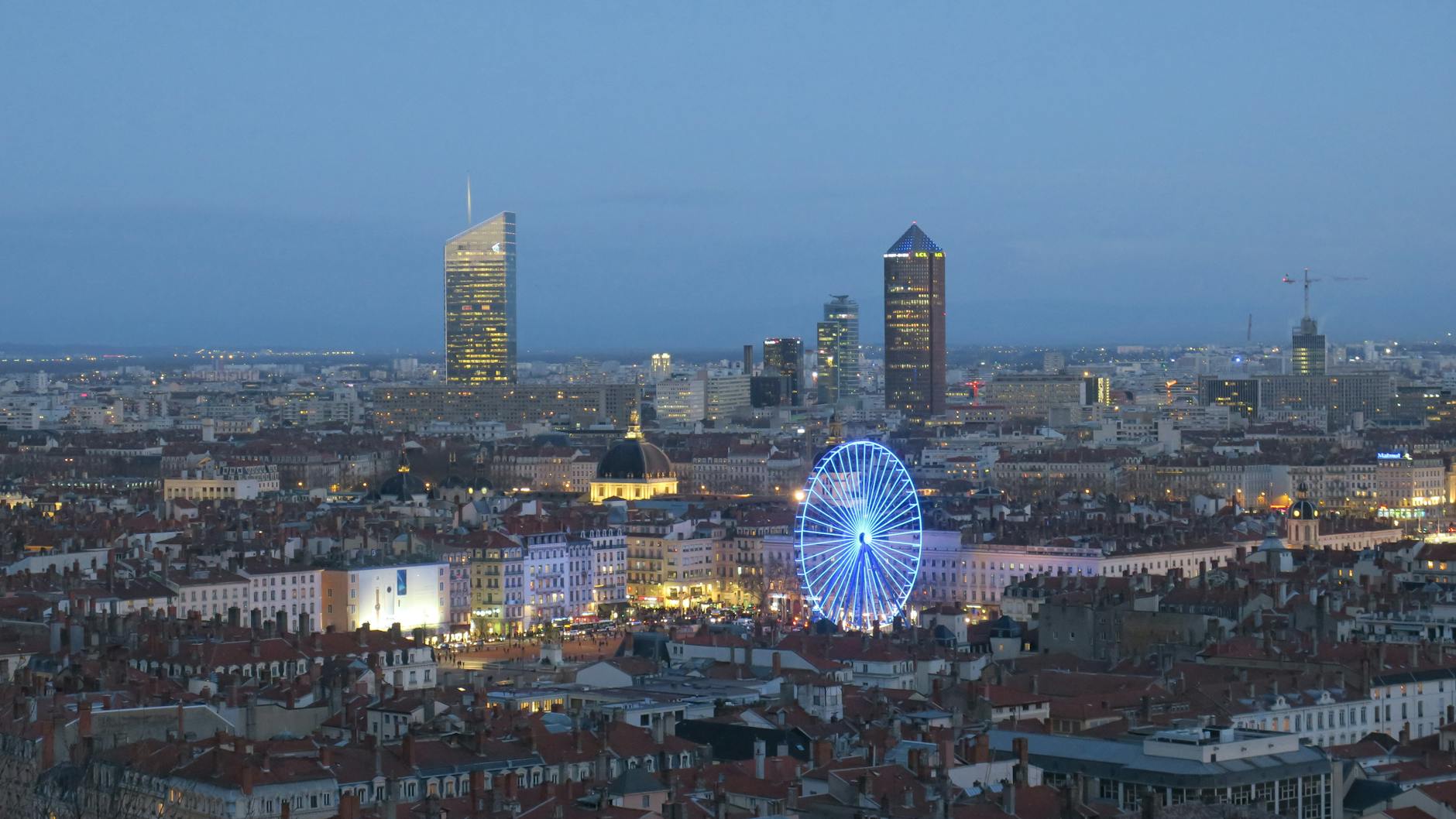 Night view of Lyon with an illuminated Ferris wheel