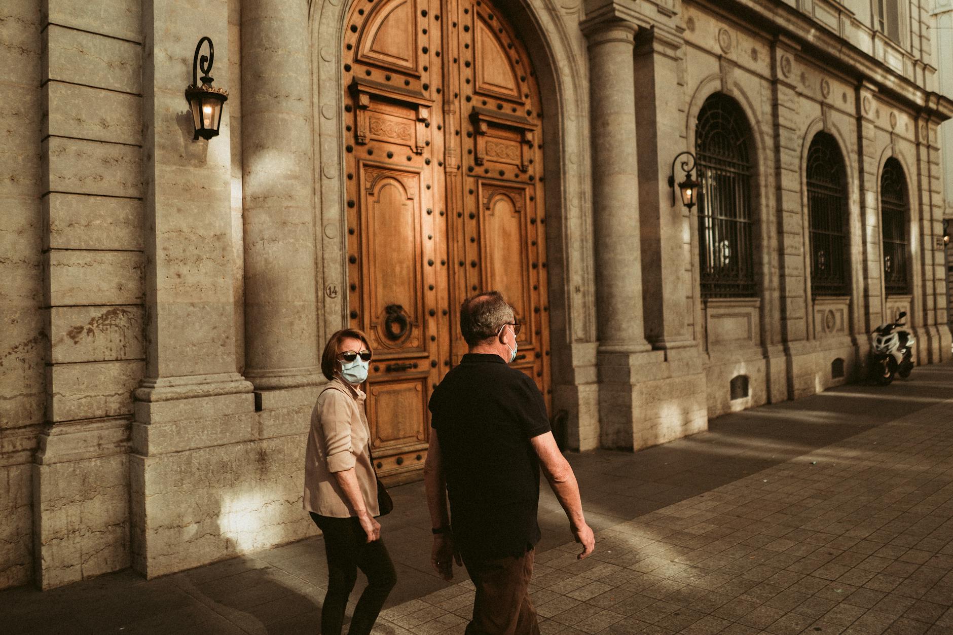 People walking beside historic architecture in Lyon