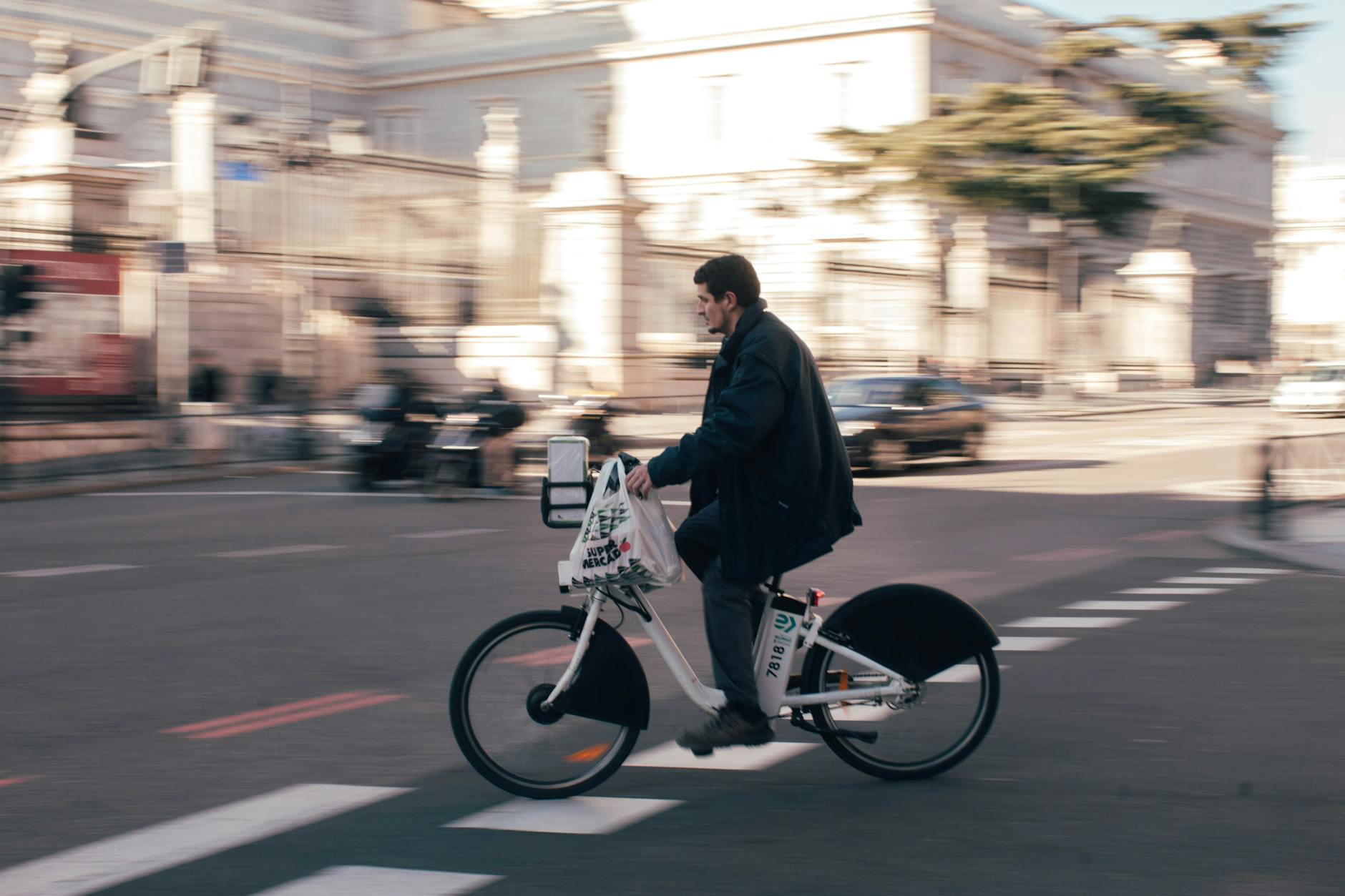 Man riding an electric bike on a Madrid street