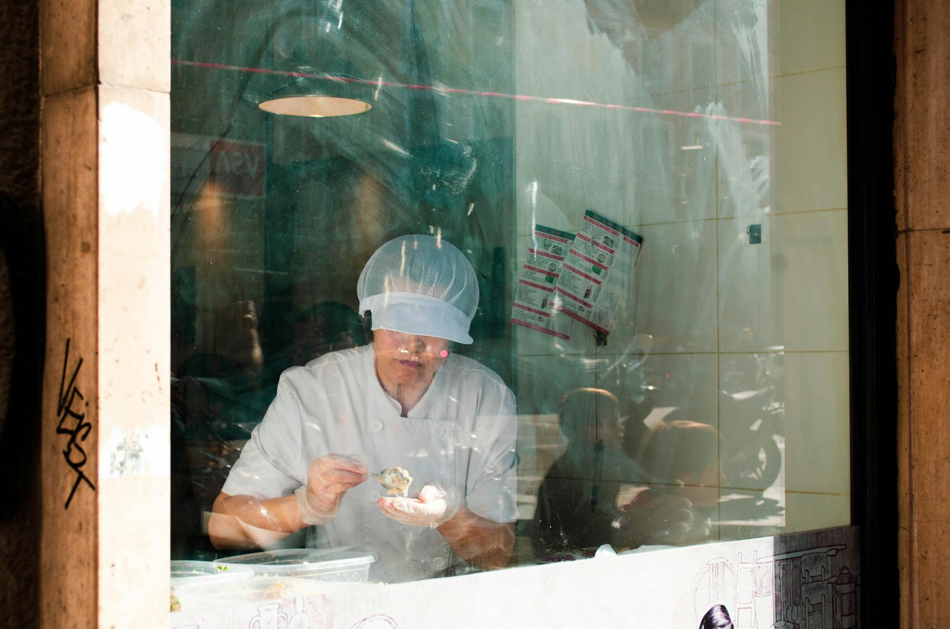 Chef working behind a glass window in Madrid