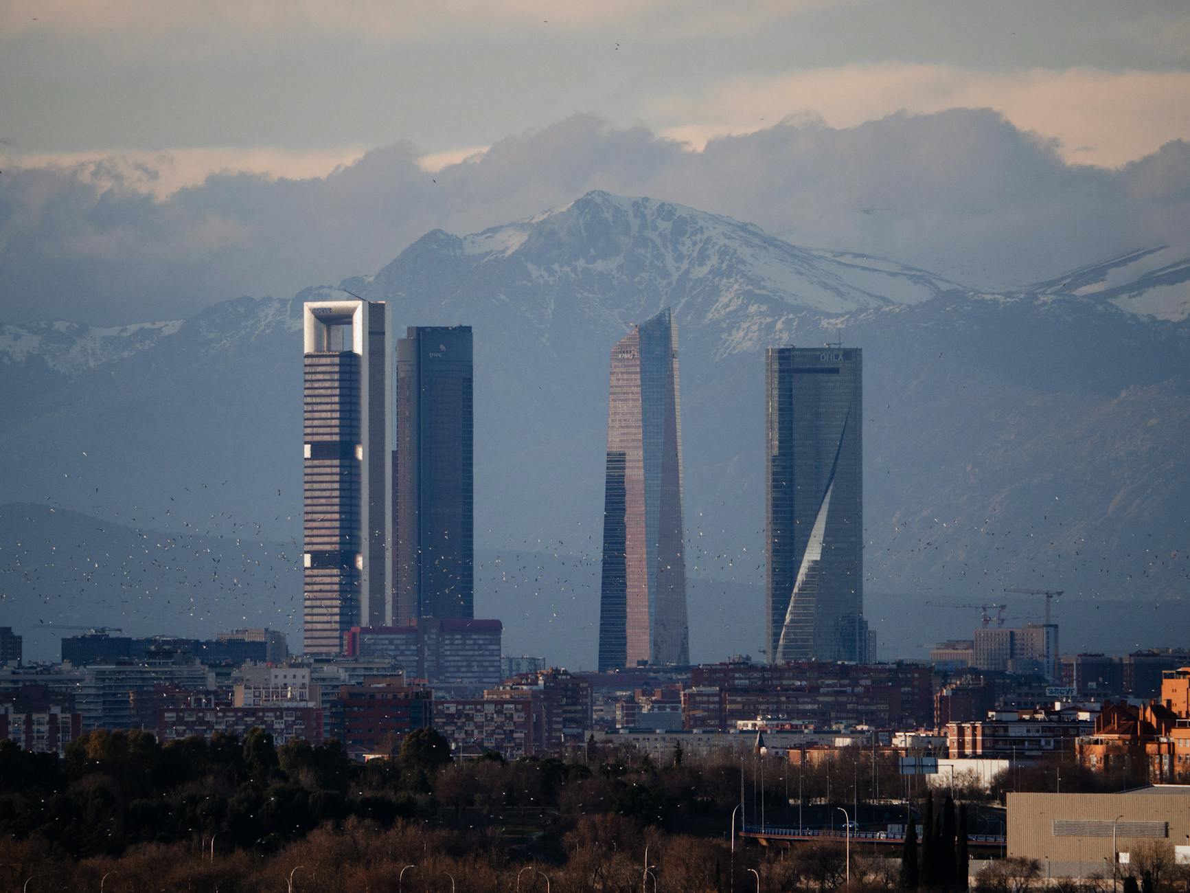 Madrid skyline with Cuatro Torres and mountains in the distance