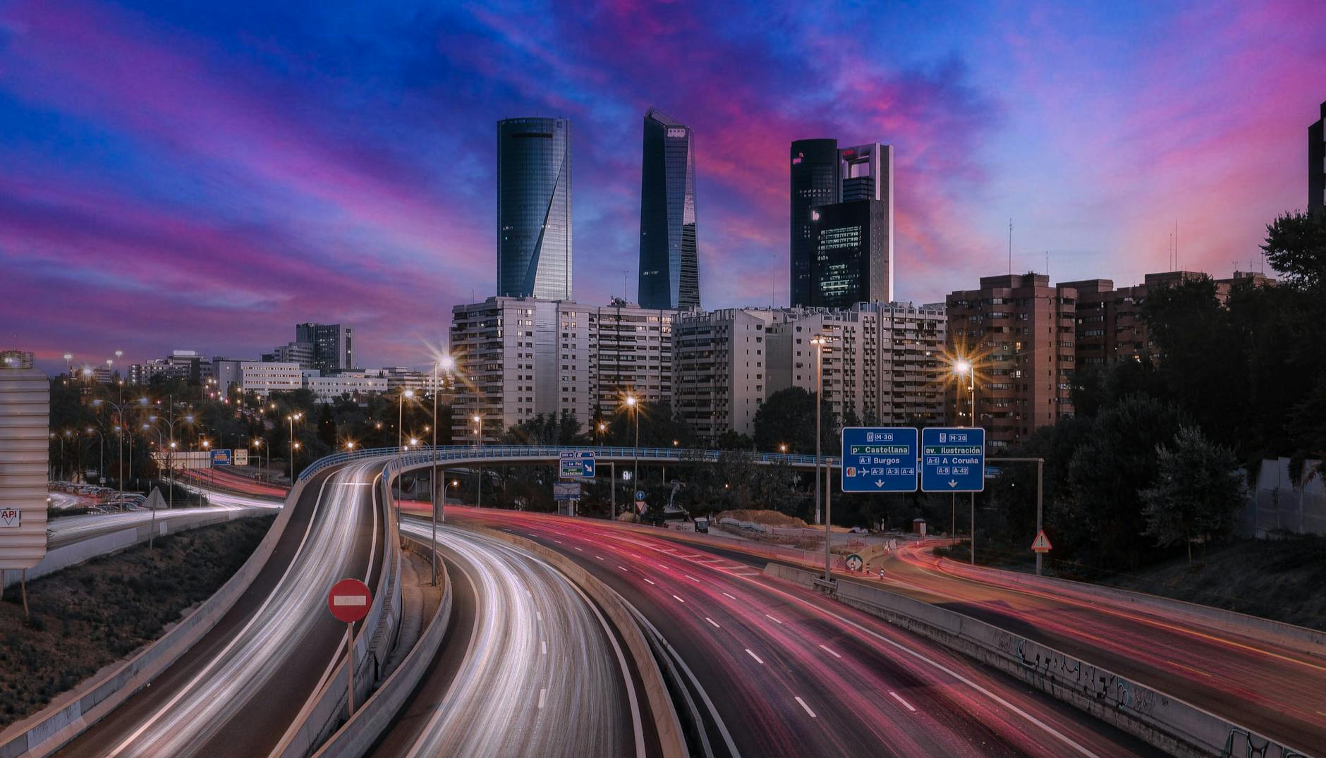 Madrid skyline and highway light trails at twilight