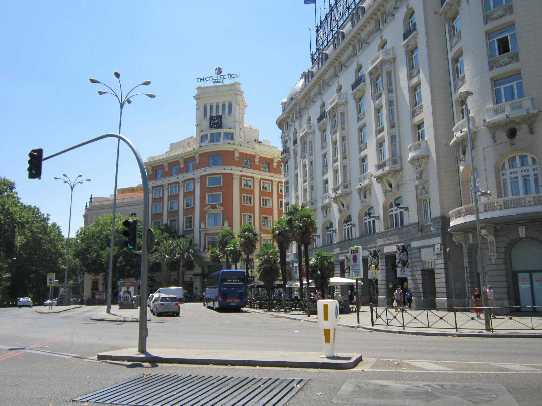 Sunlit Madrid street with central architecture near hotel districts