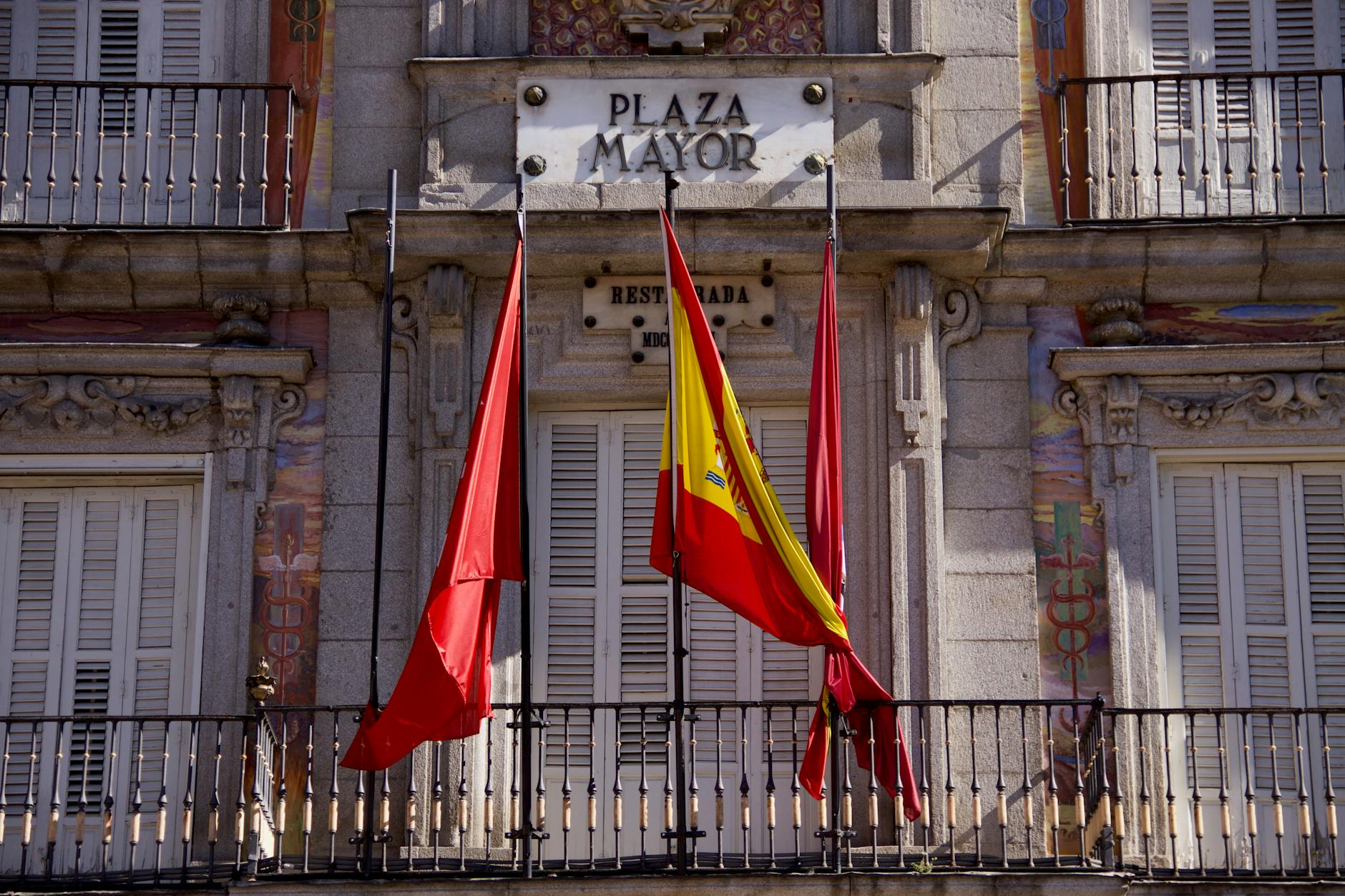 Flags and historic facade at Plaza Mayor in Madrid