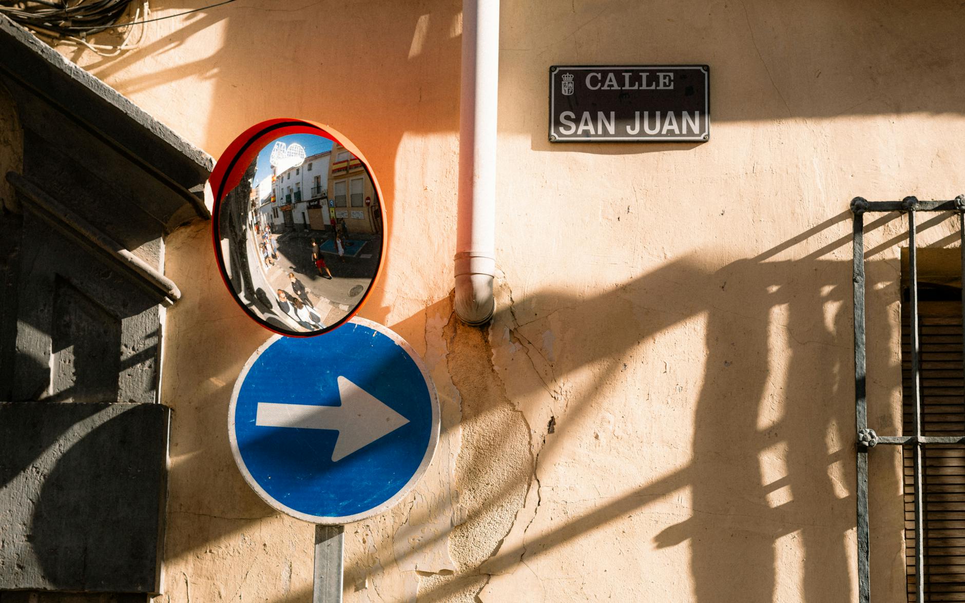 Madrid alley with street sign and mirror reflection