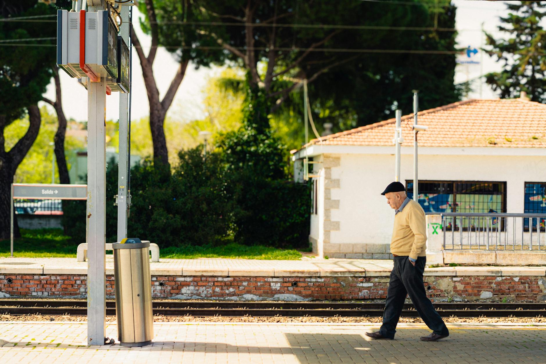 Senior traveler walking along a railway platform in Madrid
