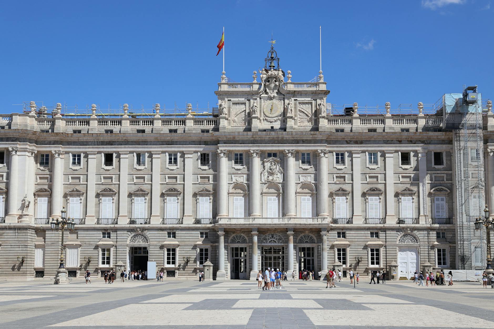 Tourists in the plaza outside the Royal Palace of Madrid