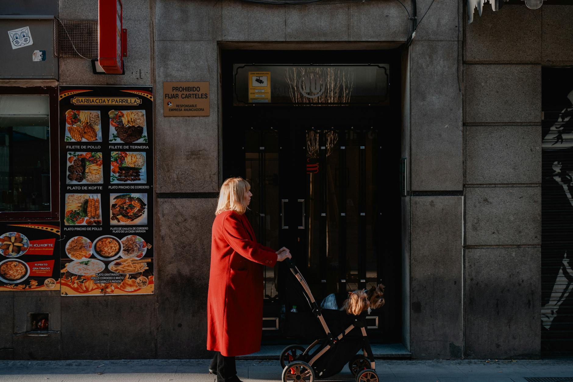 Woman walking with a stroller on a Madrid street