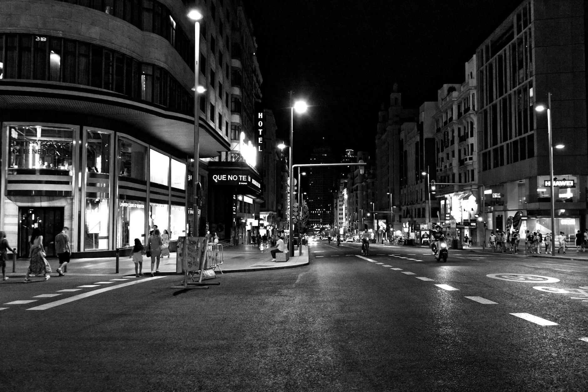 Busy Madrid street at night in black and white