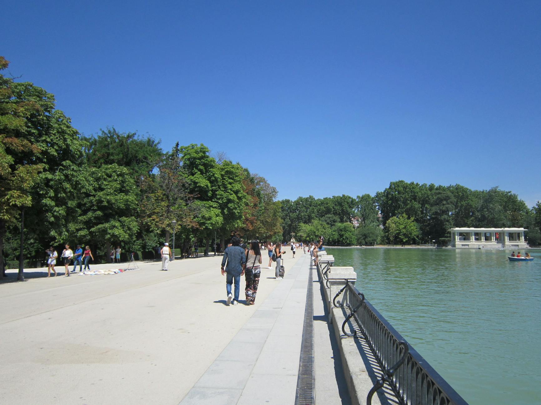 People strolling by the pond in Retiro Park in Madrid