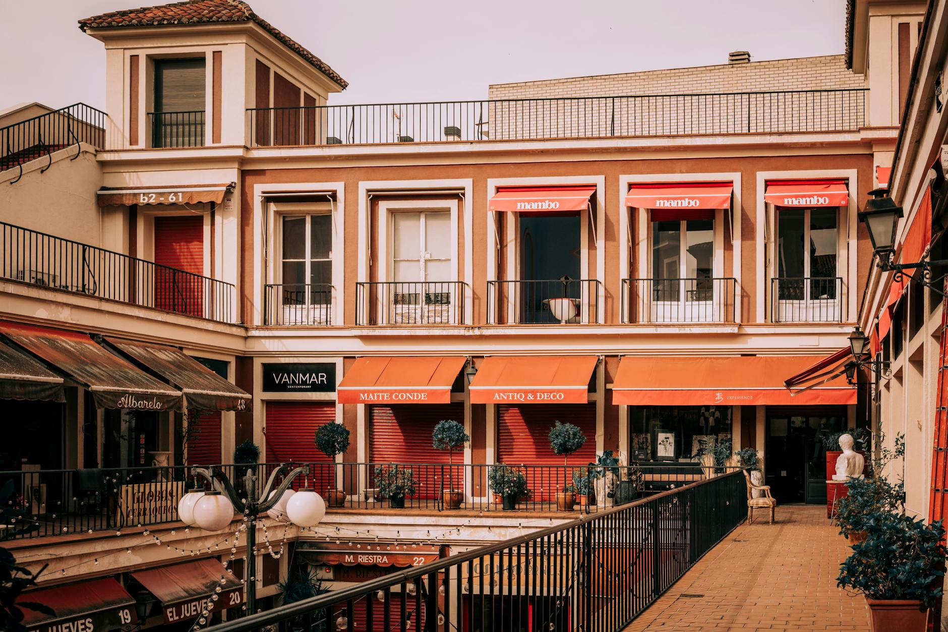 Madrid courtyard with restaurants and colorful awnings