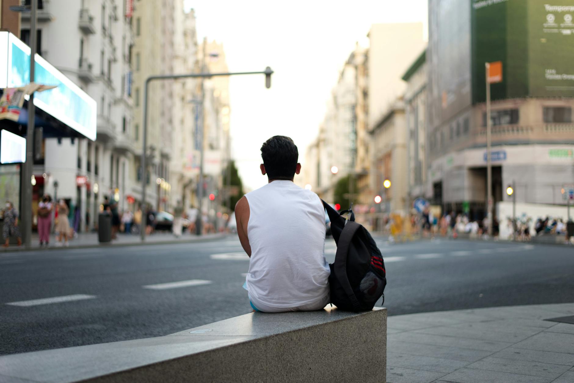 Man sitting alone on a street bench in Madrid