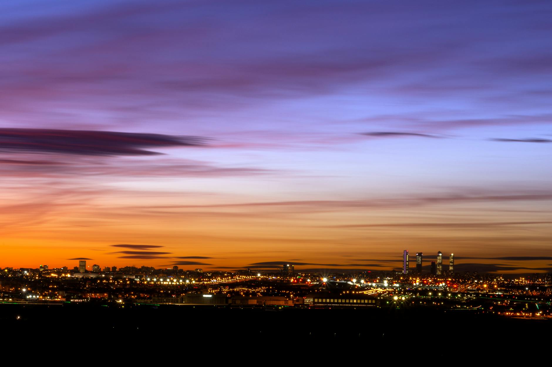 Madrid skyline at sunset with illuminated skyscrapers