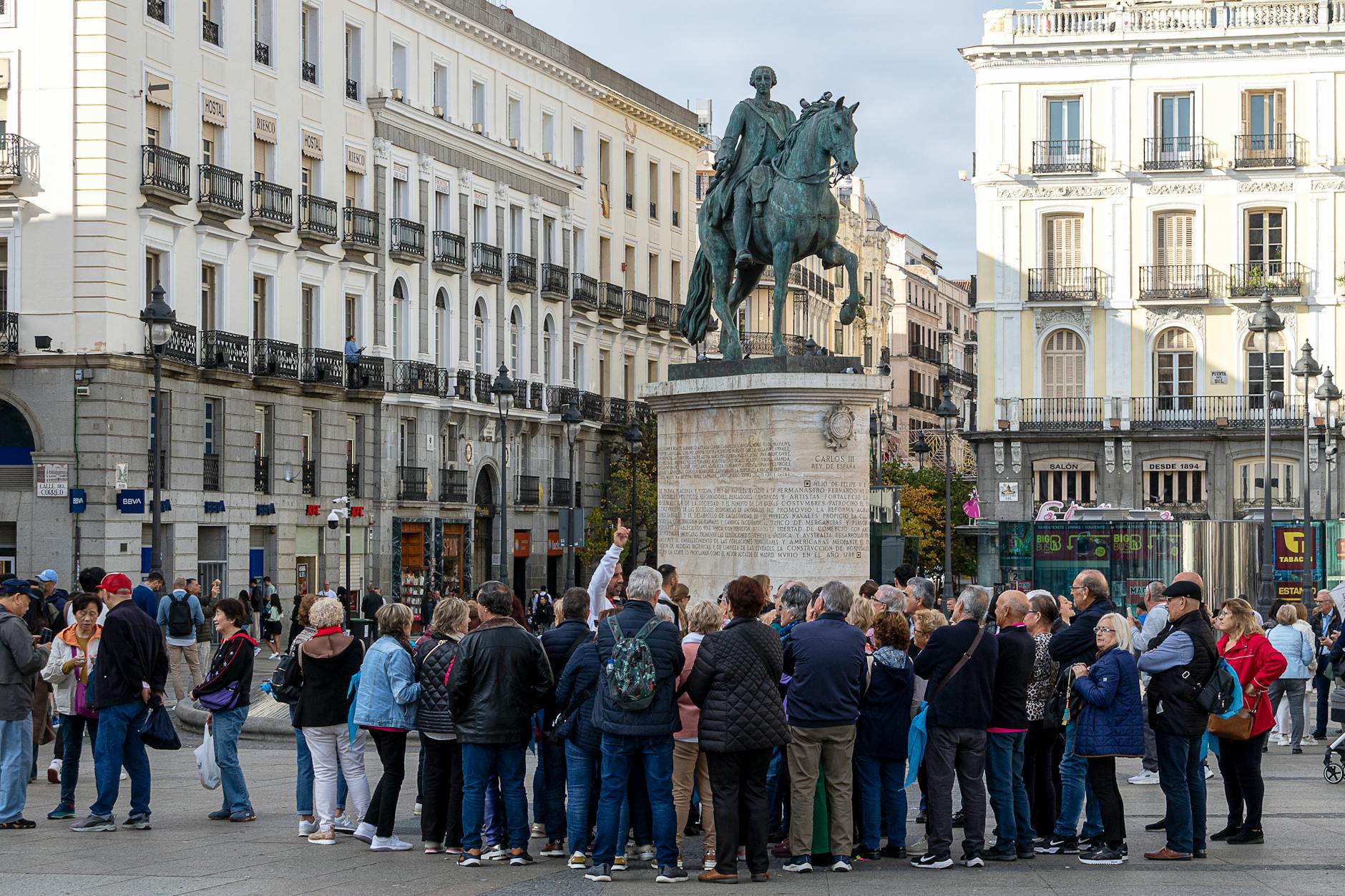 Tourists gathered around the equestrian statue in Puerta del Sol