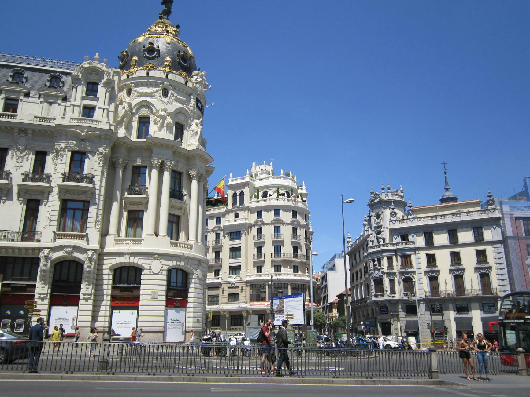 Gran Via in Madrid with classic architecture and pedestrians