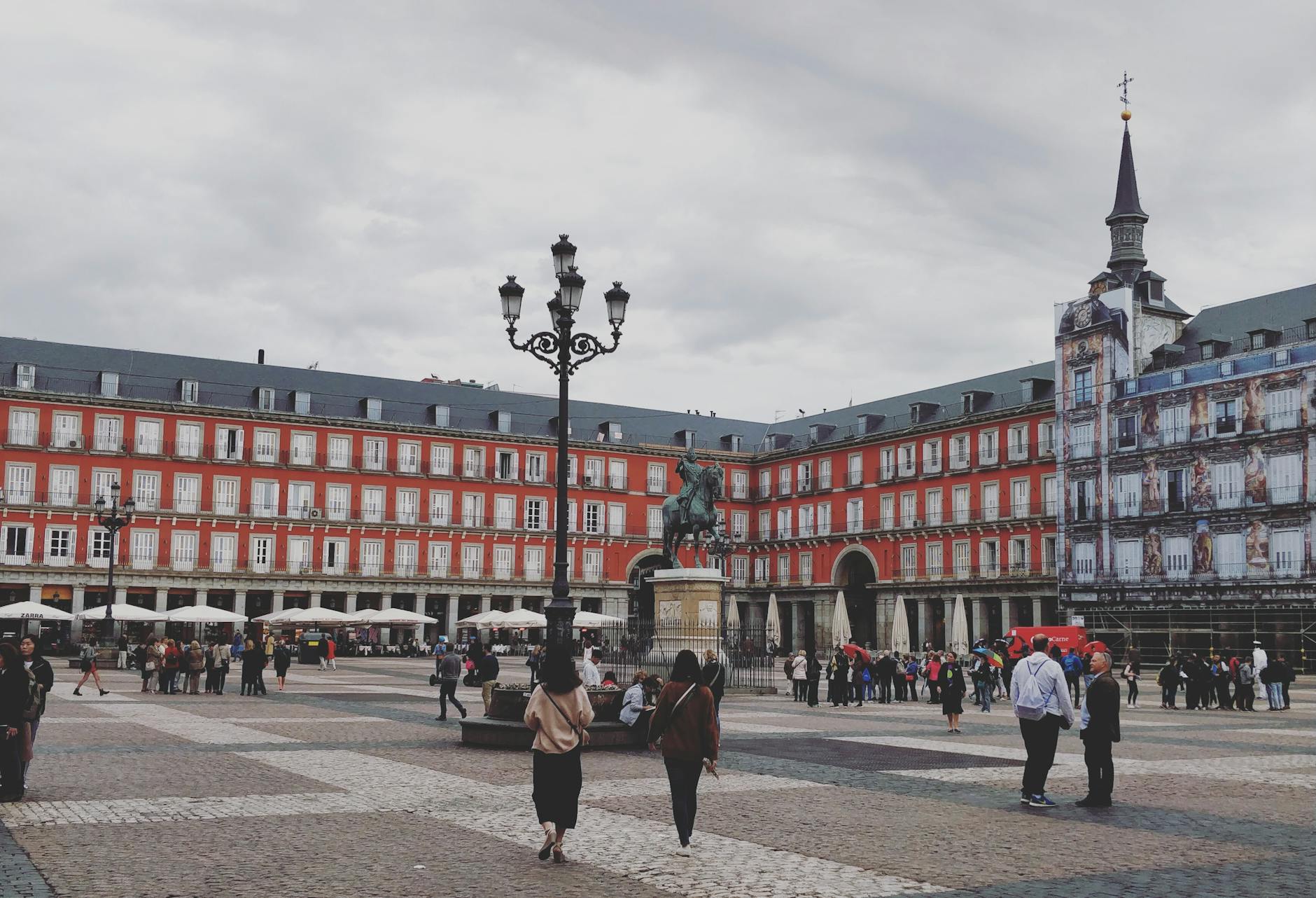 Busy Plaza Mayor in Madrid with the Philip III statue