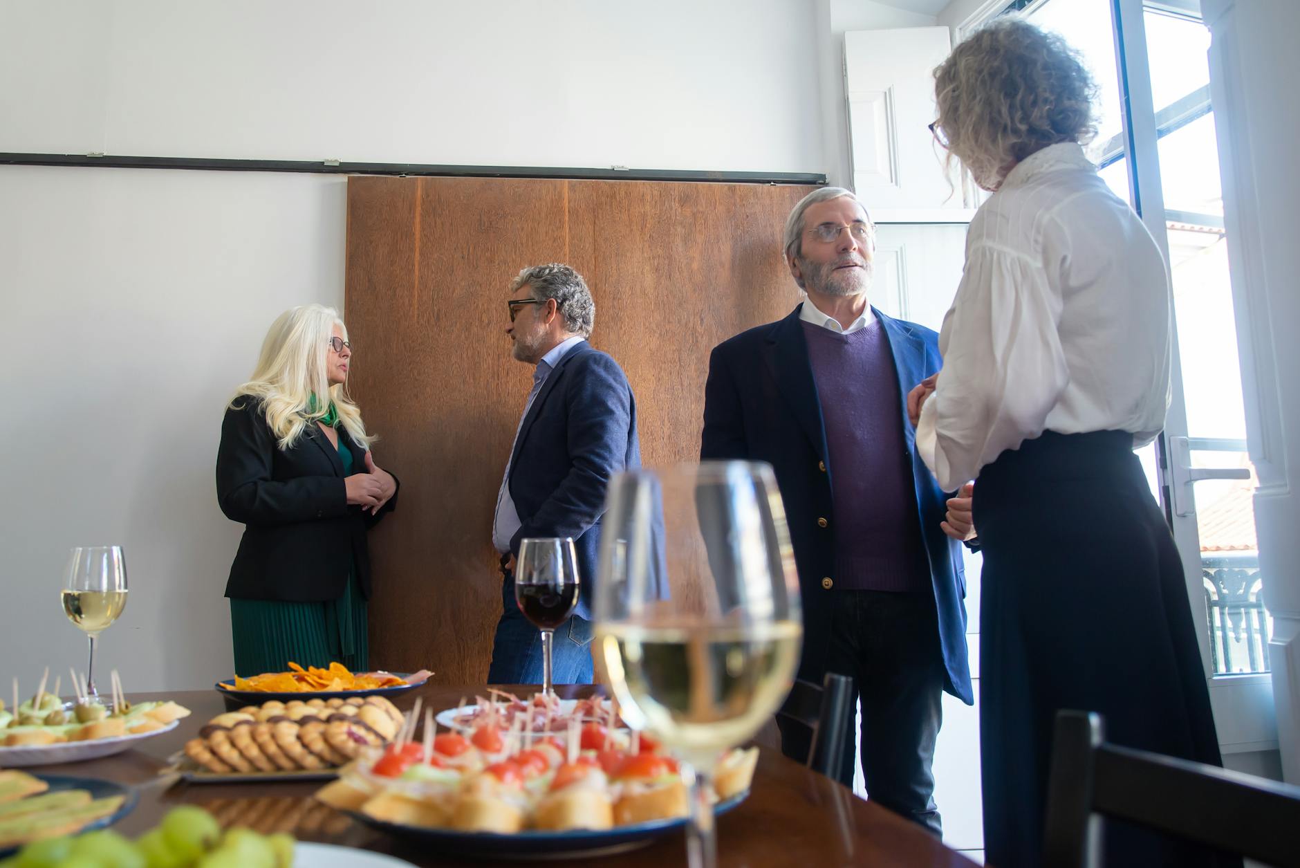 Business gathering with drinks, snacks, and conversation