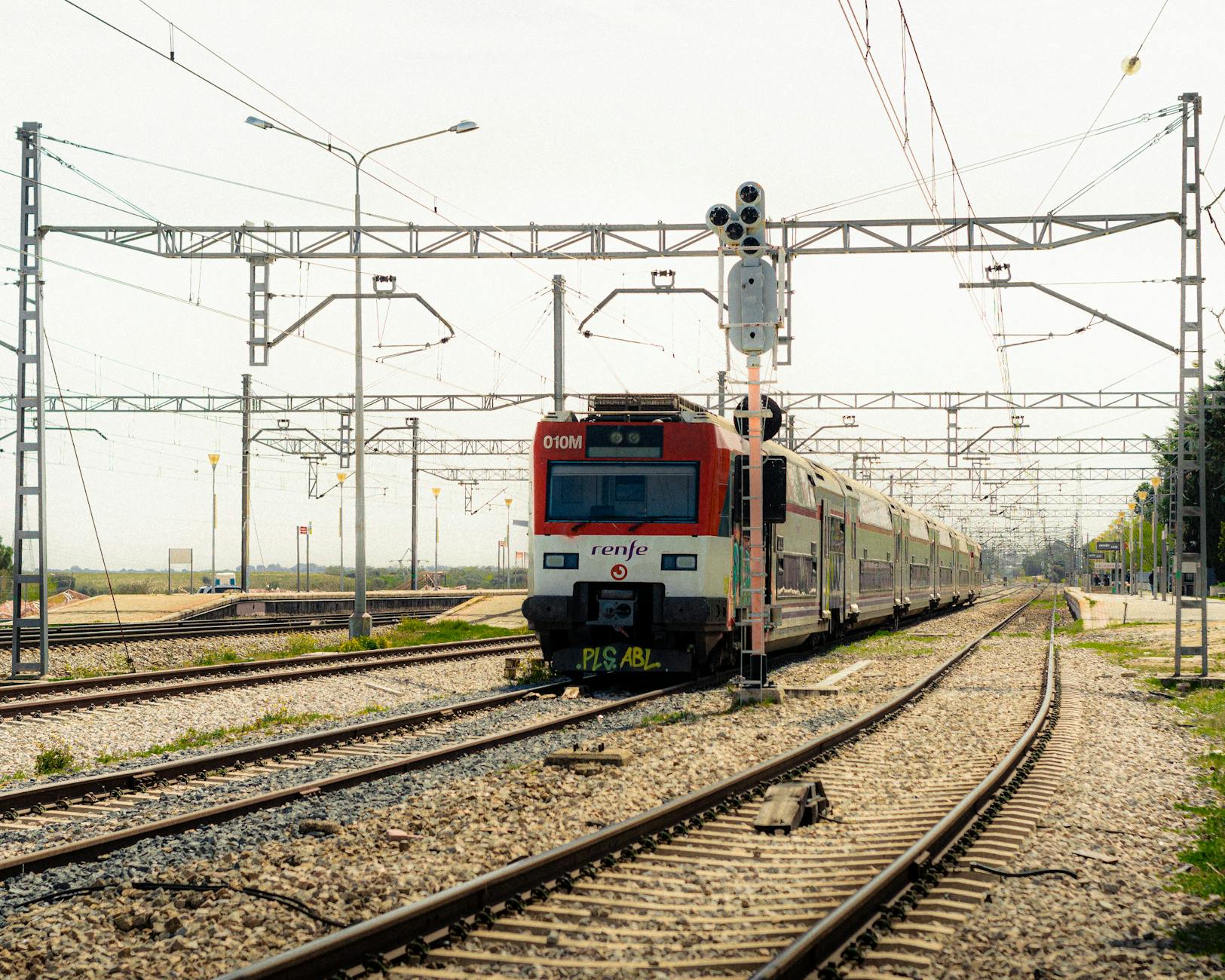 Renfe train traveling on railway tracks in Madrid